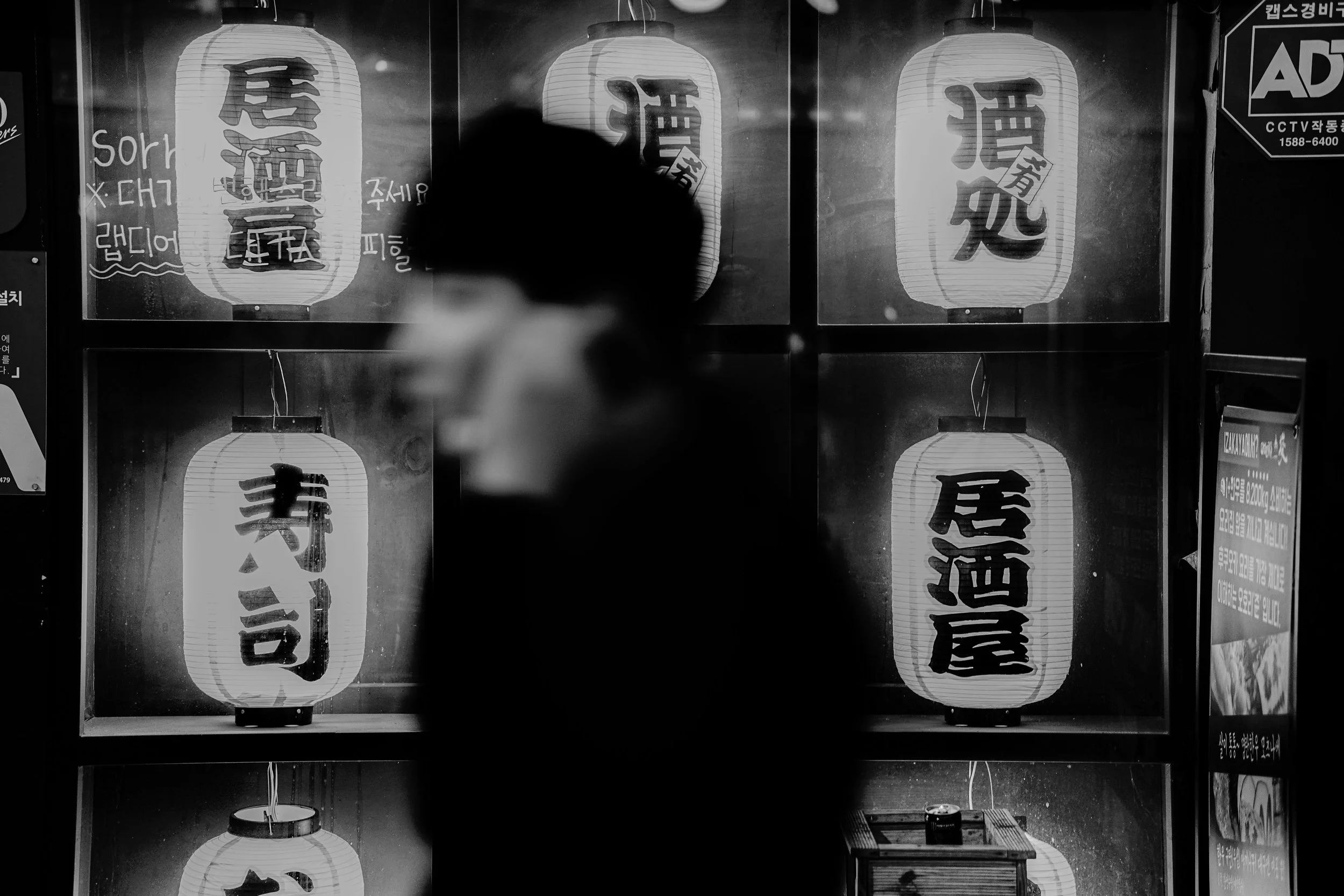 Daegu: Between glowing lanterns and fading shadows, a fleeting face becomes part of the city’s night.