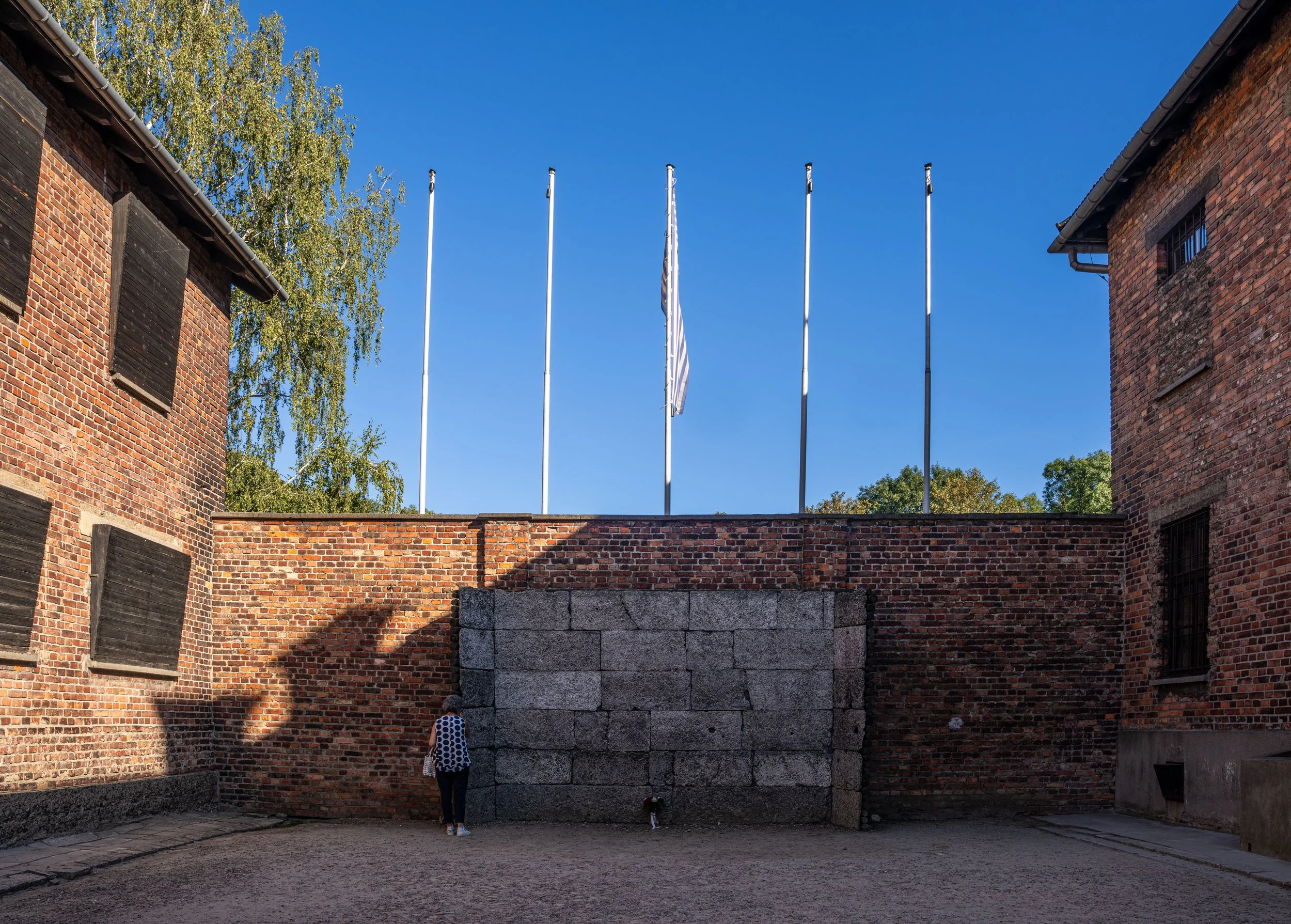 Here, prisoners were lined up and executed. The wall still carries the weight of those final moments.