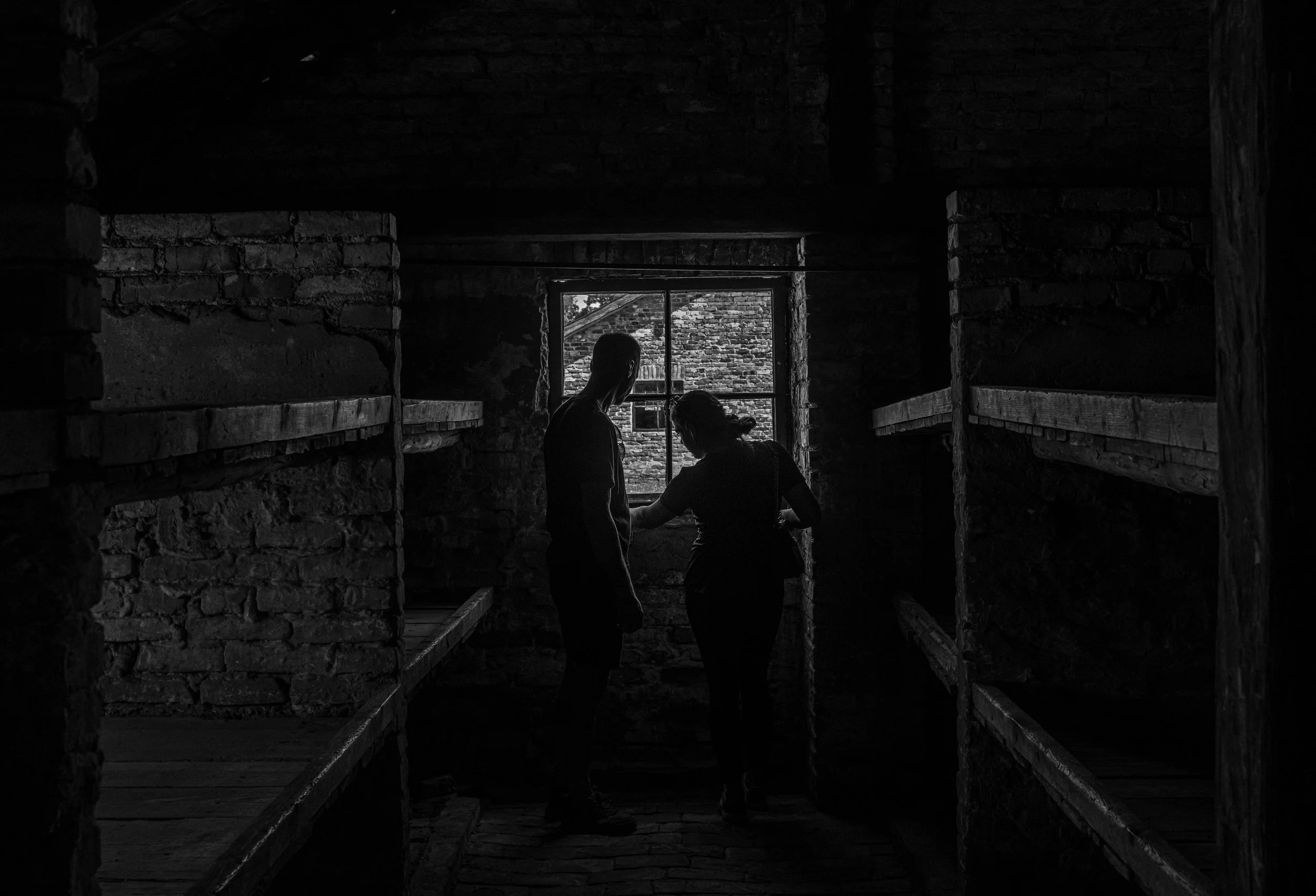 Shadows of the past: narrow wooden bunks where countless lives were reduced to numbers, hunger, and despair.