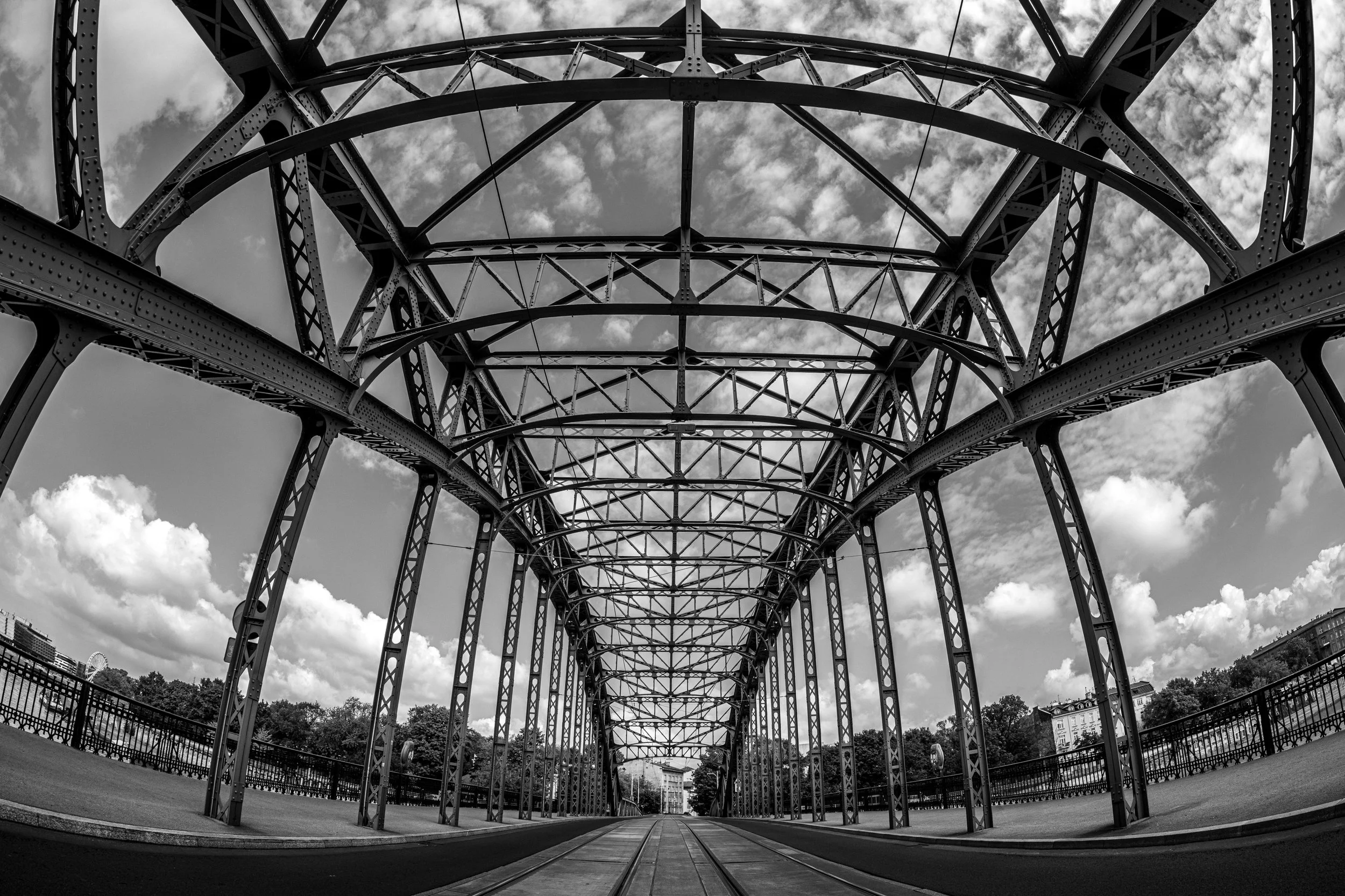 Krakow, Bridge - Silence woven in metal, solitude beneath clouds, a bridge suspends time between absence and presence.