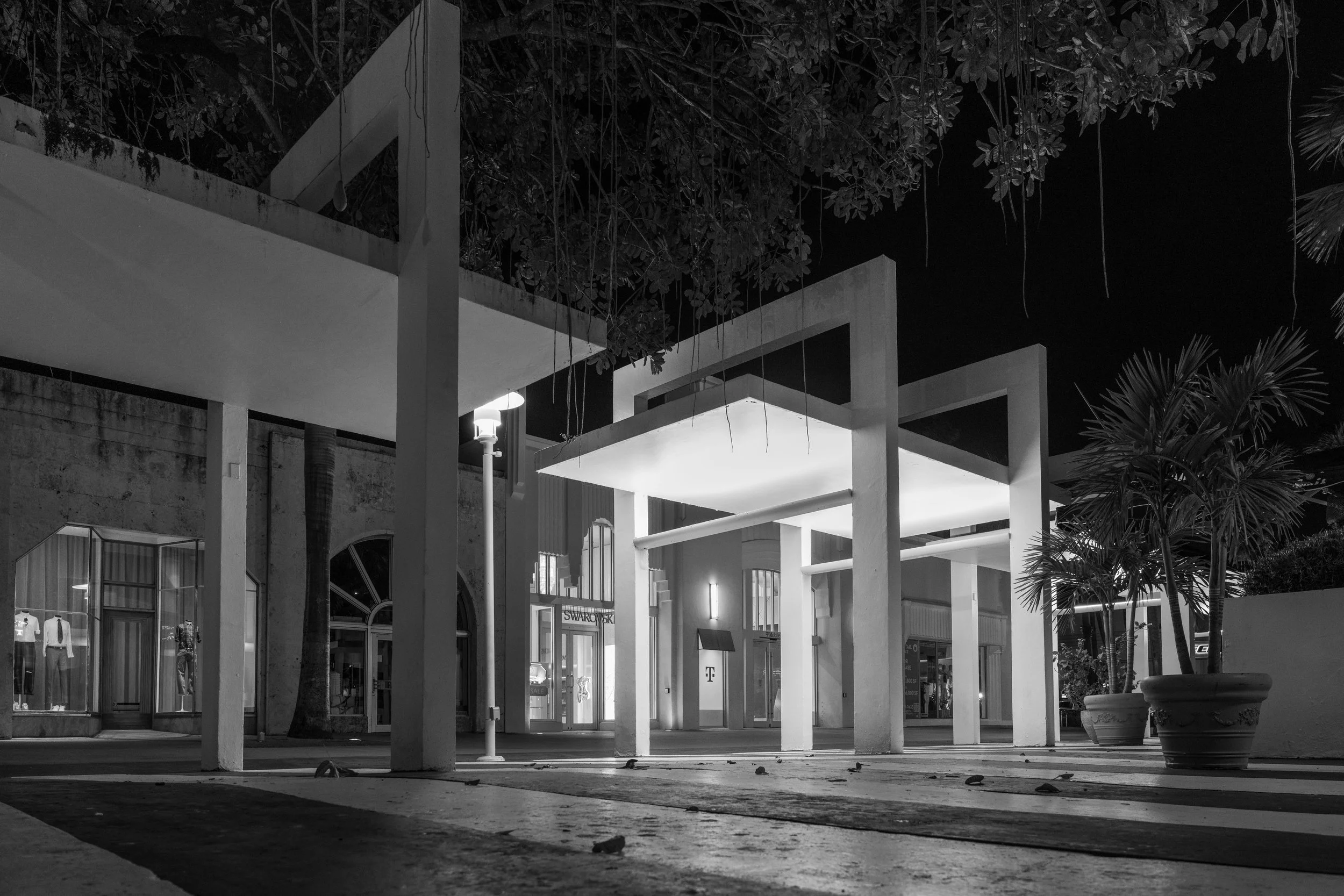 Miami - Silent structures glow against night, casting measured shadows, where emptiness becomes architecture’s whispered poetry.