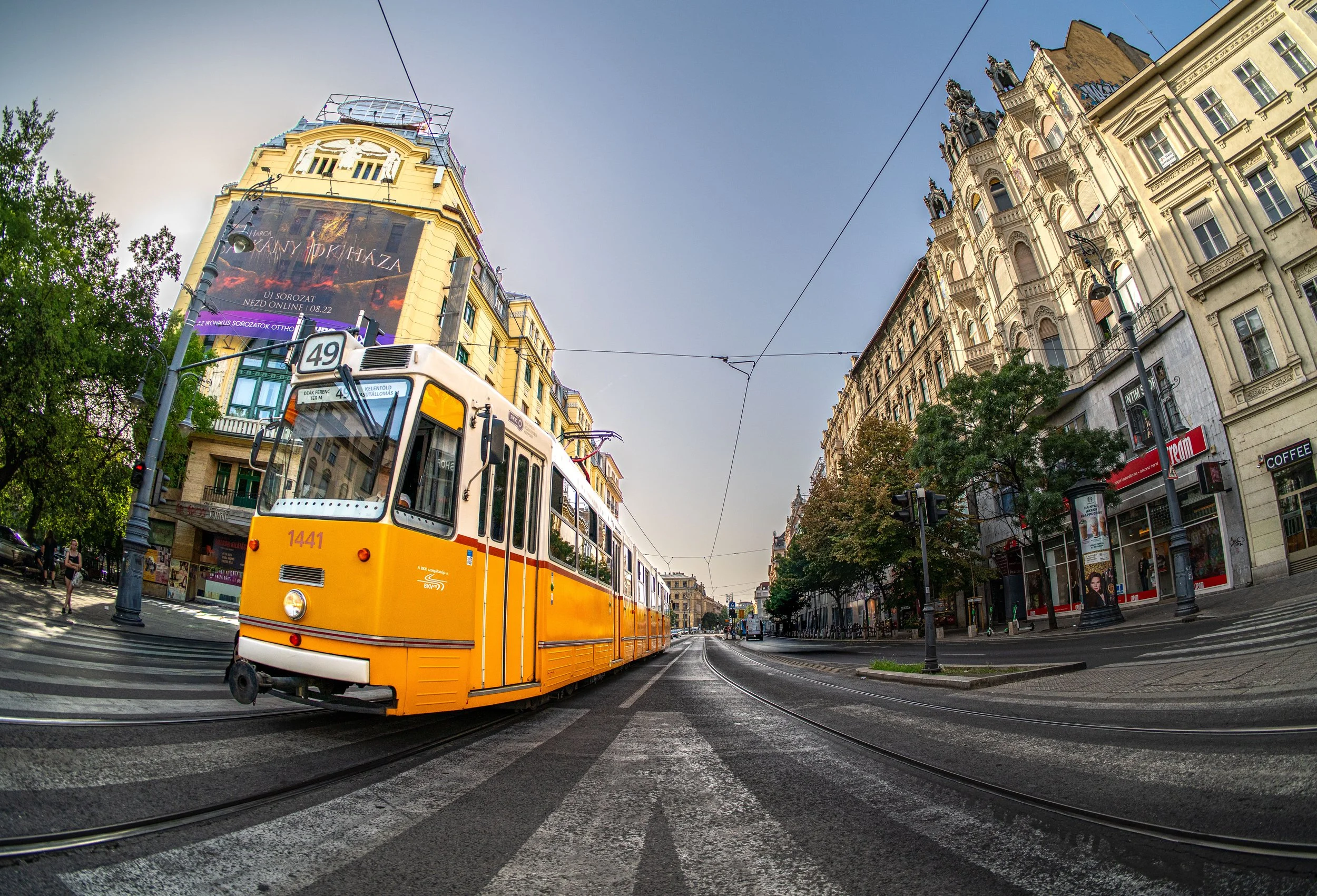 Budapest breathes in motion, as the tram paints golden lines across its living canvas of history.