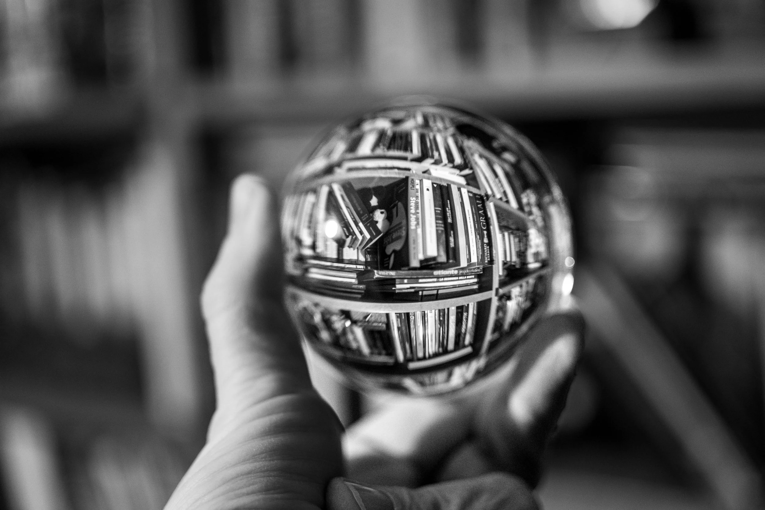 My Library – Worlds reflected in glass, each book a doorway, infinite stories condensed into fragile light.