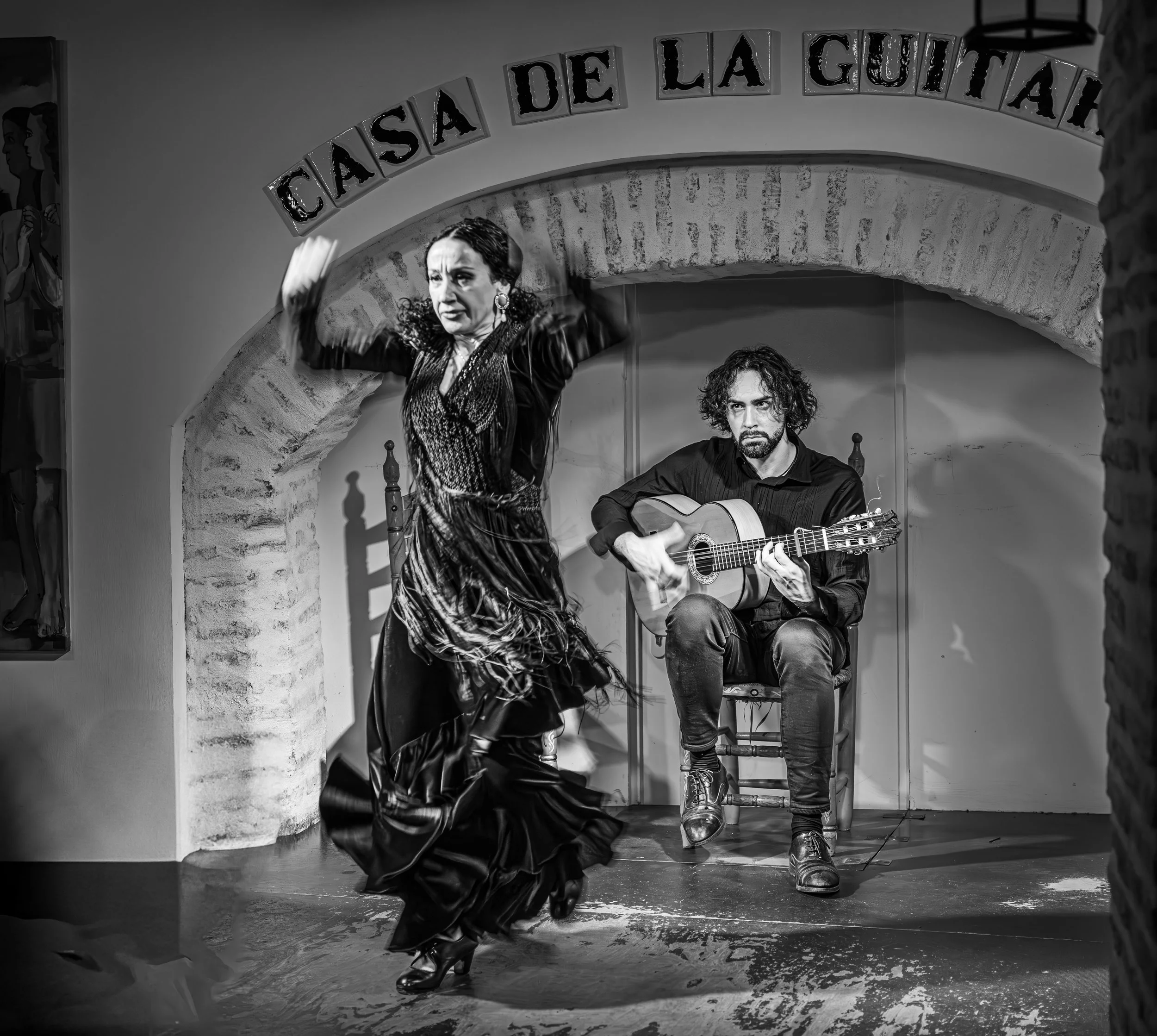 Sevilla - Her body strikes the air, echoing guitar strings, rhythm painted in shadows and fire.