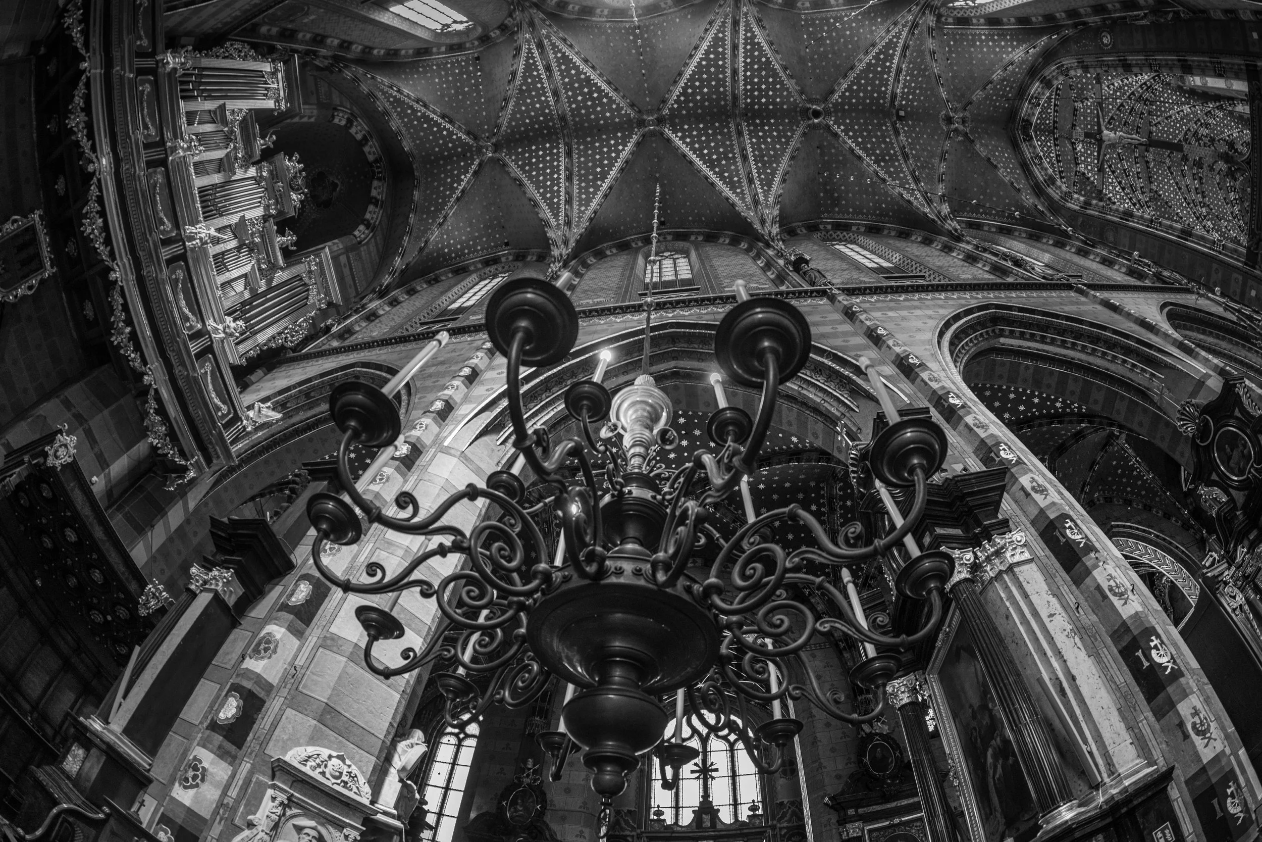 Krakow – The weight of faith carved in stone, the glow of centuries suspended in wrought iron and echoes.