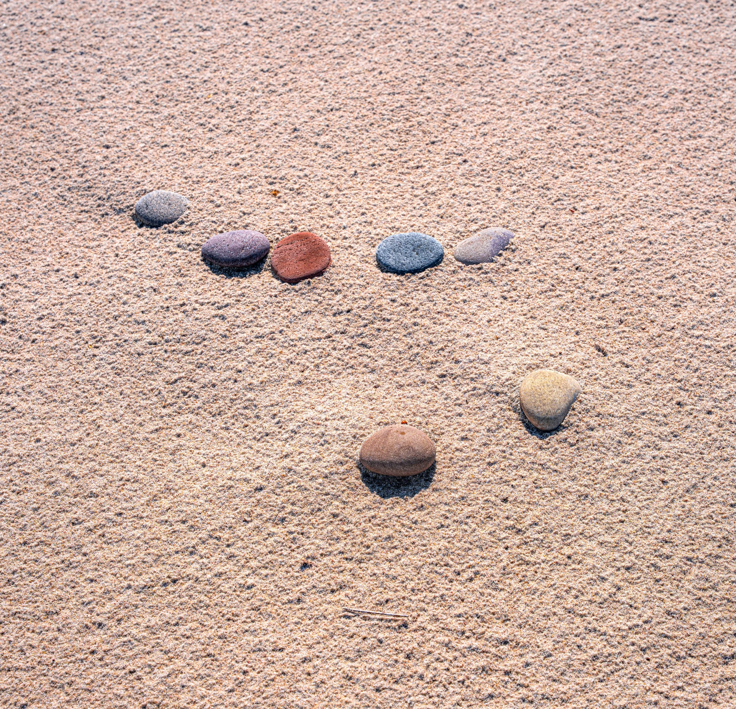 Neringa – Pebbles on a golden shore, simplicity turned into a silent mosaic of nature.