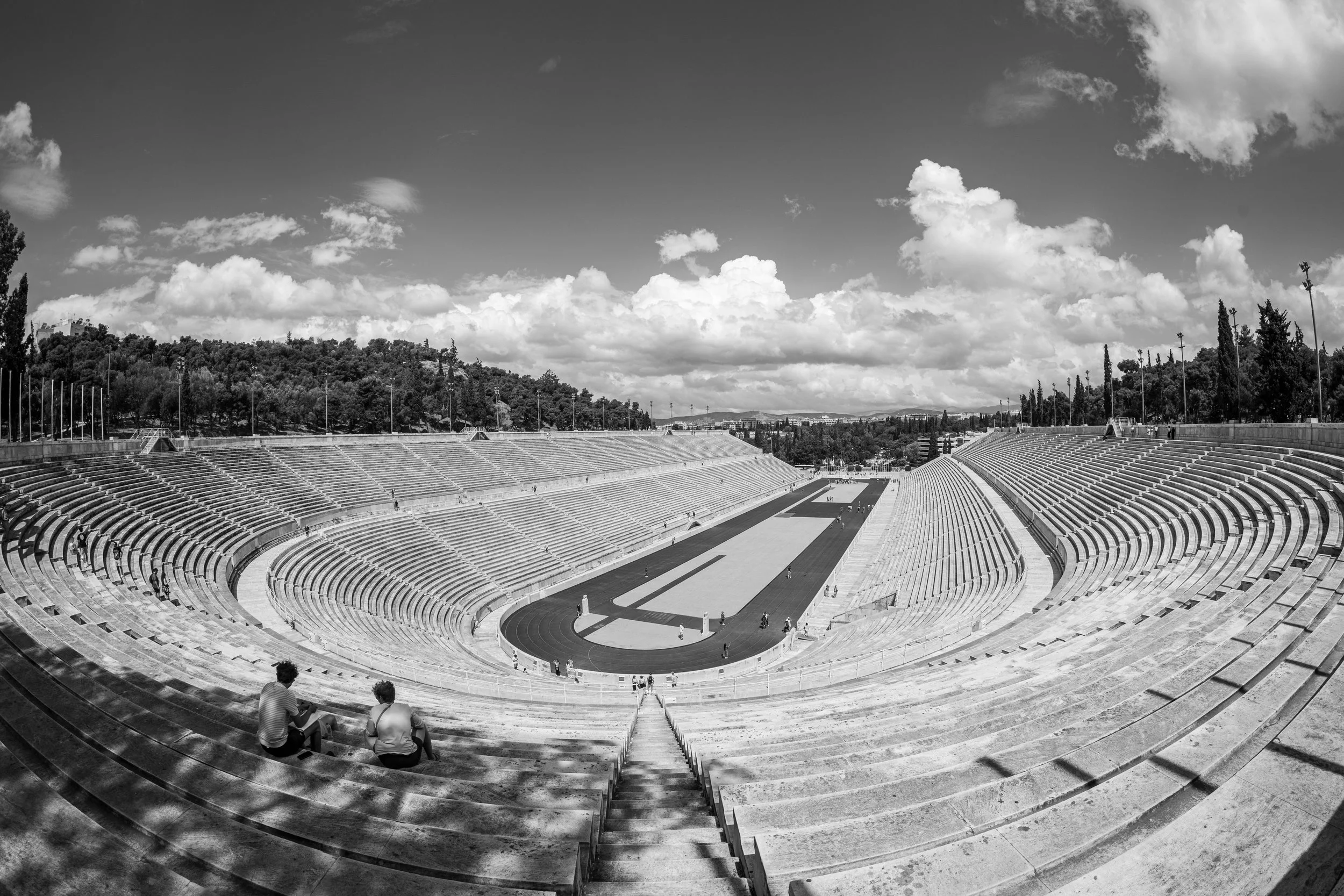 Athens - Stone remembers forgotten voices, where athletes carved eternity and history still breathes through marble silence.