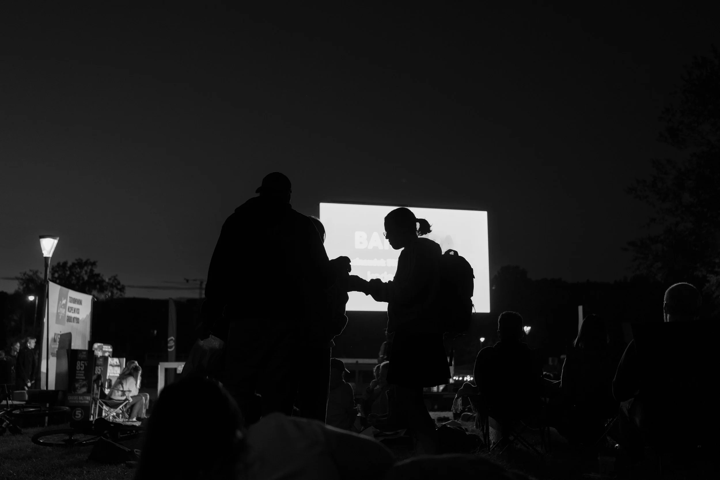 Vilnius: Shadows gather before the glowing screen, where night turns into story.