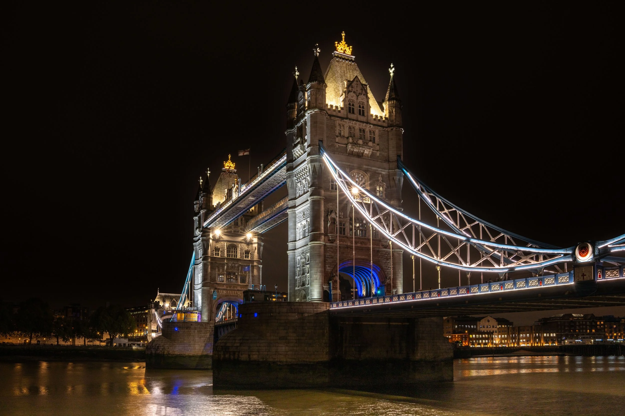 London, Tower Bridge - Victorian engineering meets city lights, a monument bridging centuries with glowing strength.