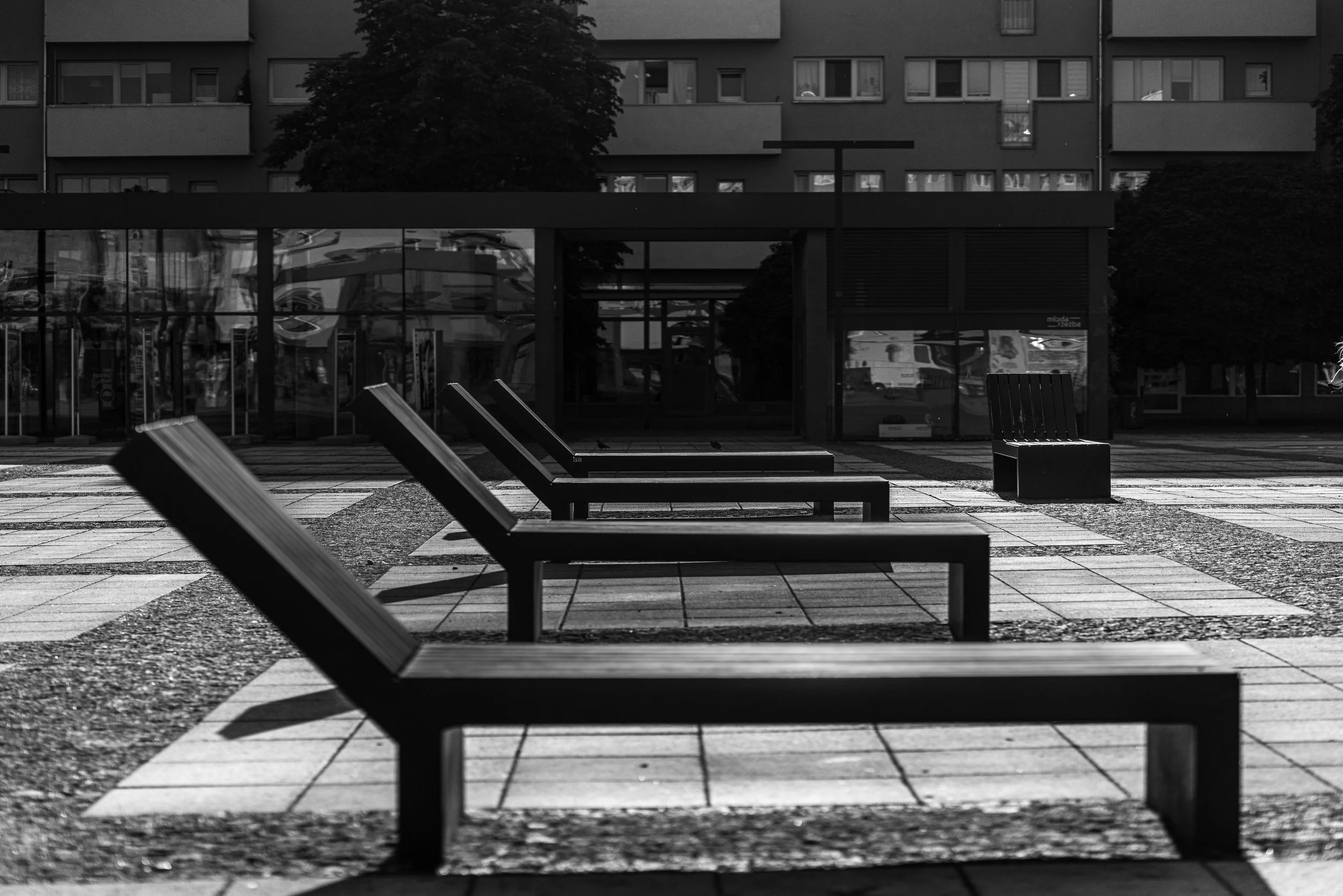 Wrocław - Empty chairs align in rhythm, waiting for voices that never arrive. Silence becomes geometry.
