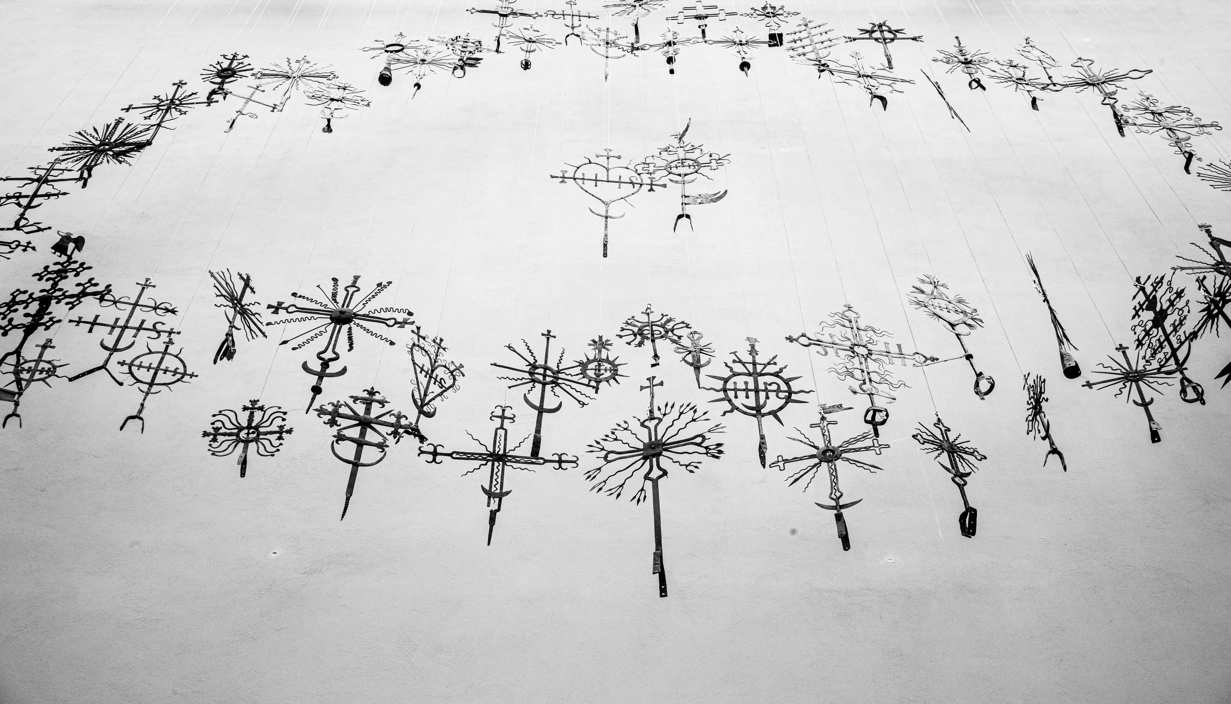 Kaunas - Suspended iron crosses cast shadows, preserving folk faith, resilience, and centuries of sacred tradition.
