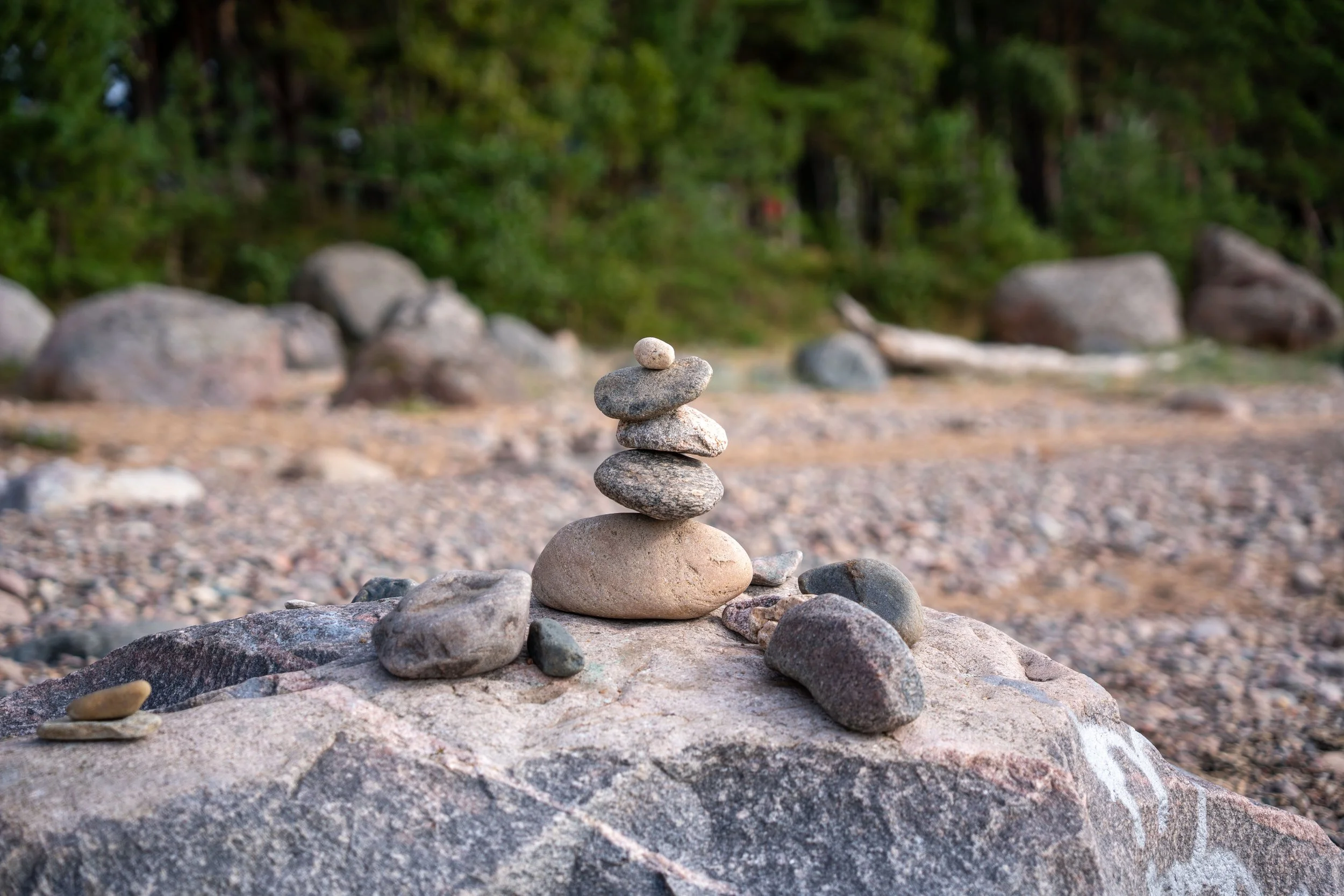 Baltic Sea – A cairn rises softly from the shore, marking time’s passage with delicate equilibrium.