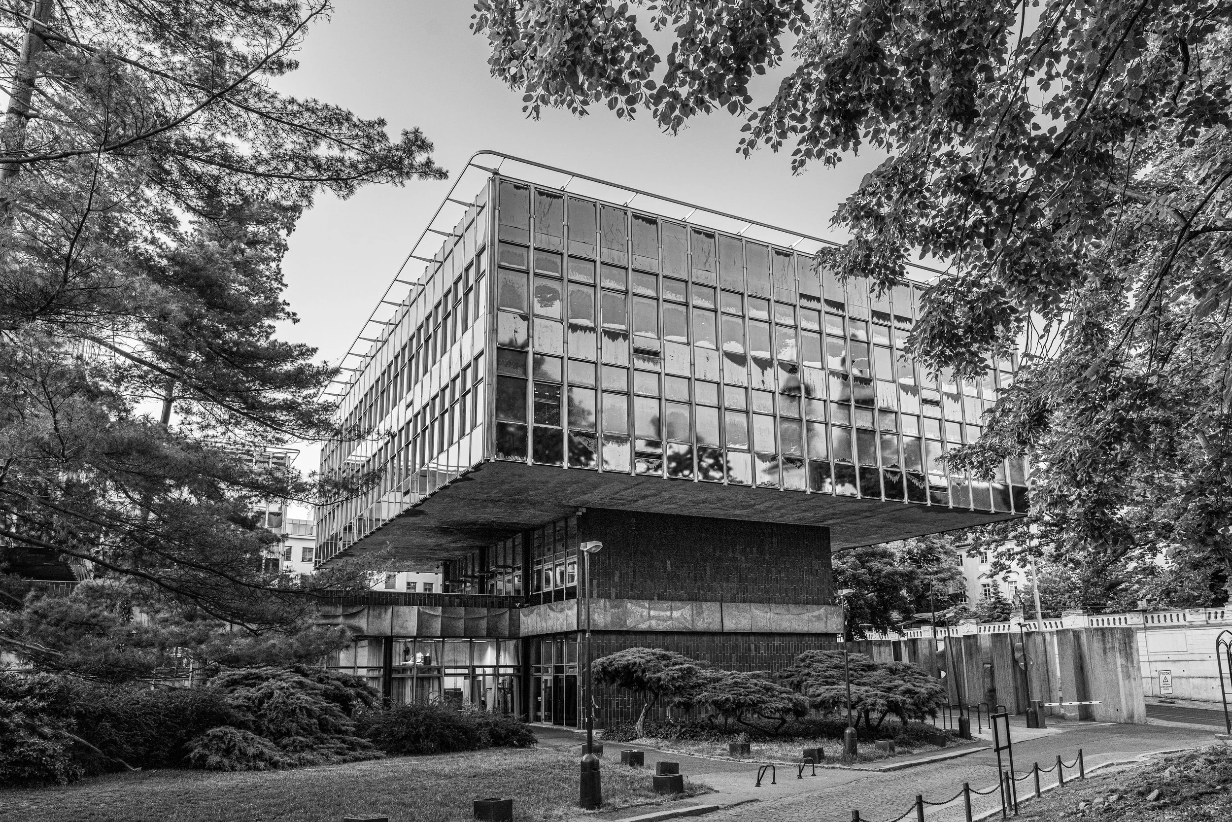Prague: A suspended block of glass and concrete, mirroring the sky while holding in silence the weight of its modern architecture.