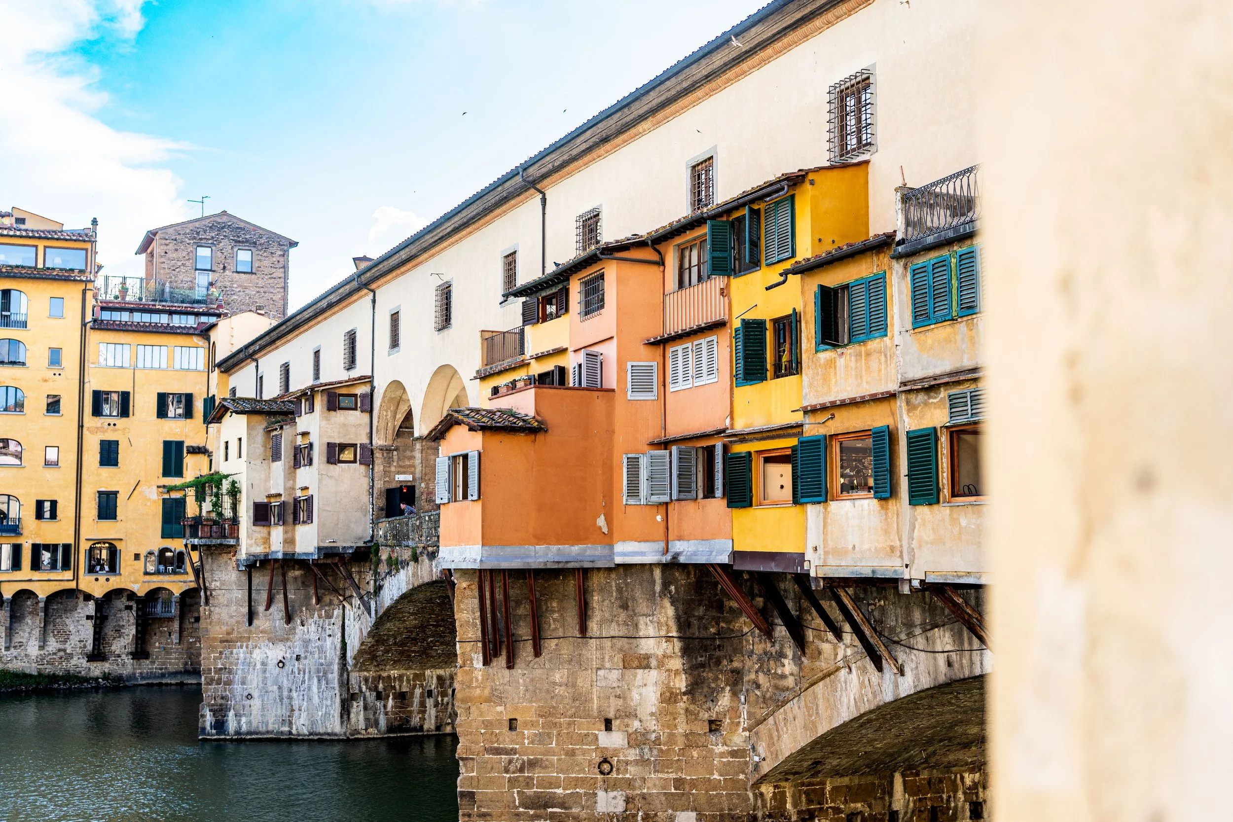 Florence, Ponte Vecchio - Golden arches and colorful walls whisper merchants’ voices, Renaissance commerce flowing across the Arno.