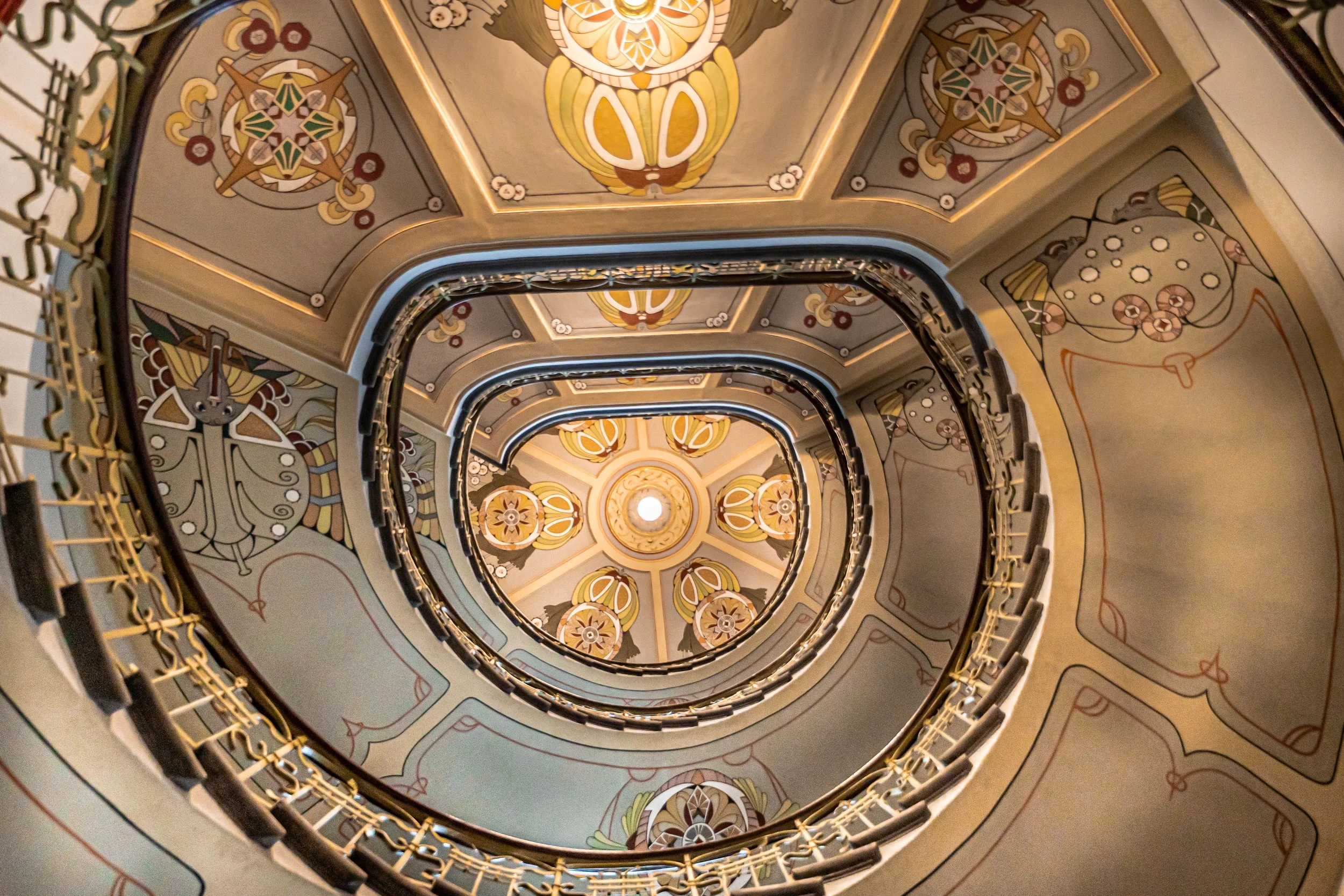 Riga, Art Nouveau staircase — Spiraling ascent crowned with floral patterns, echoing Jugendstil elegance and timeless architectural poetry.