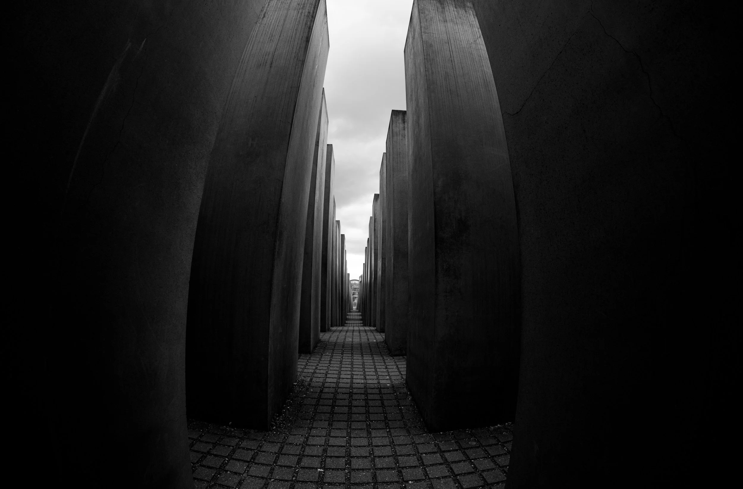 Berlin, Holocaust Memorial: A maze of shadows and light, echoing memory in every step.