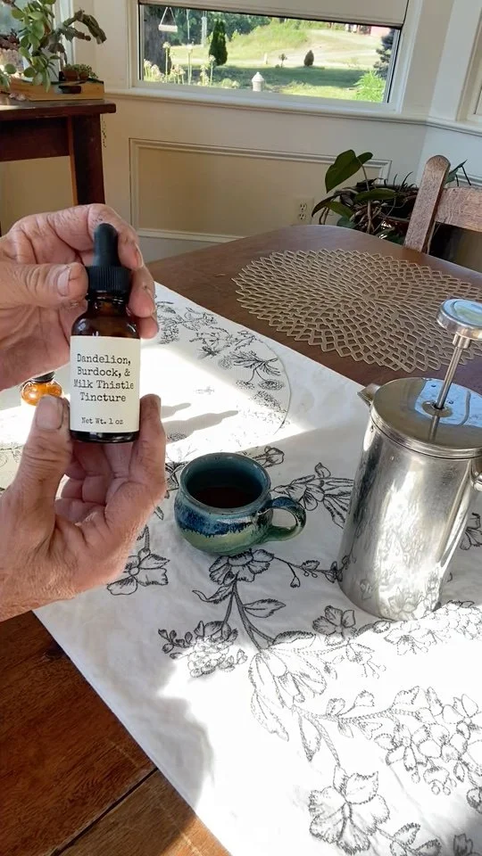 Hands holding up Dandelion, Burdock, & Milk Thistle Tincture bottle