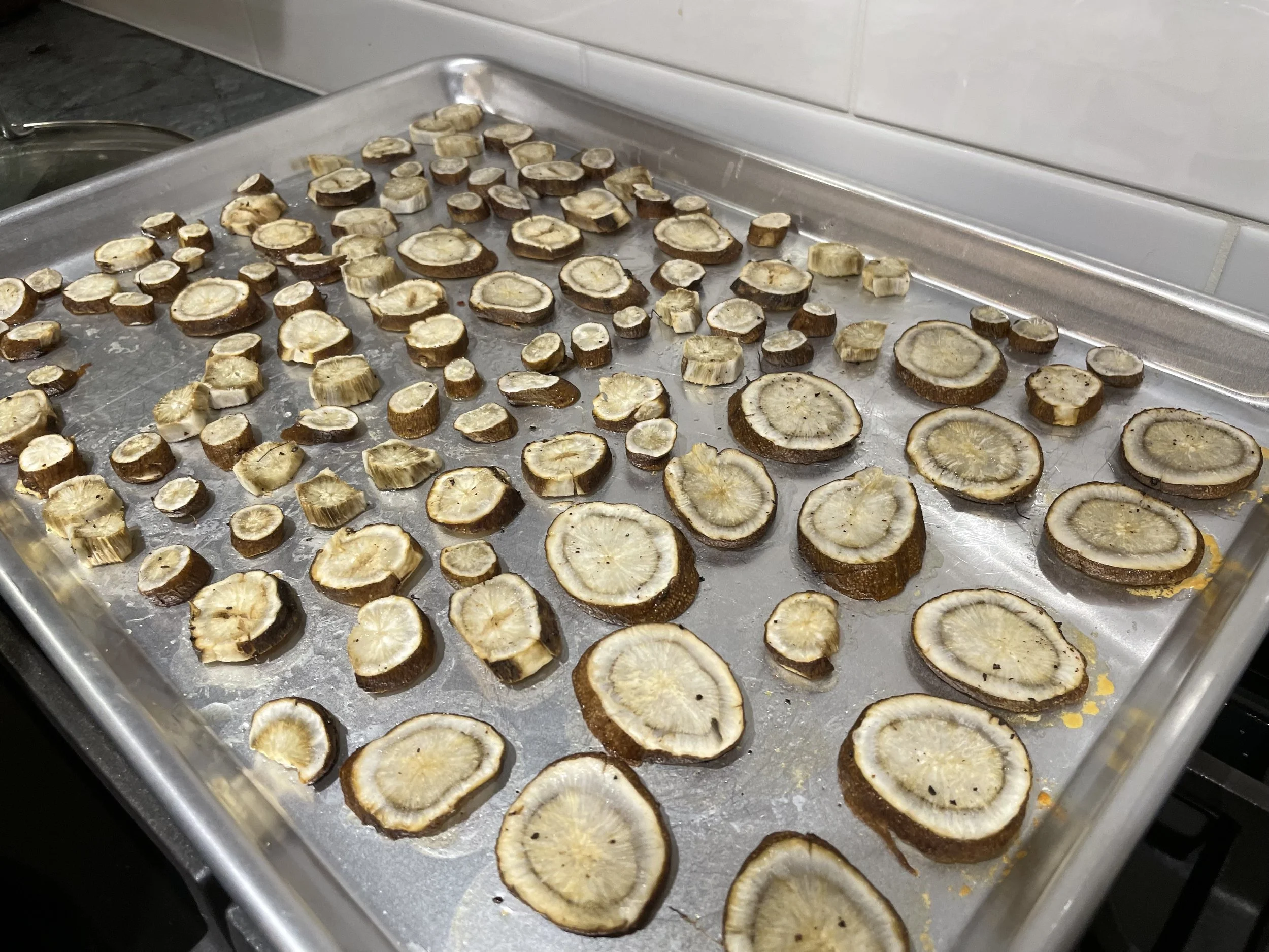 Slices of burdock root on a metal tray
