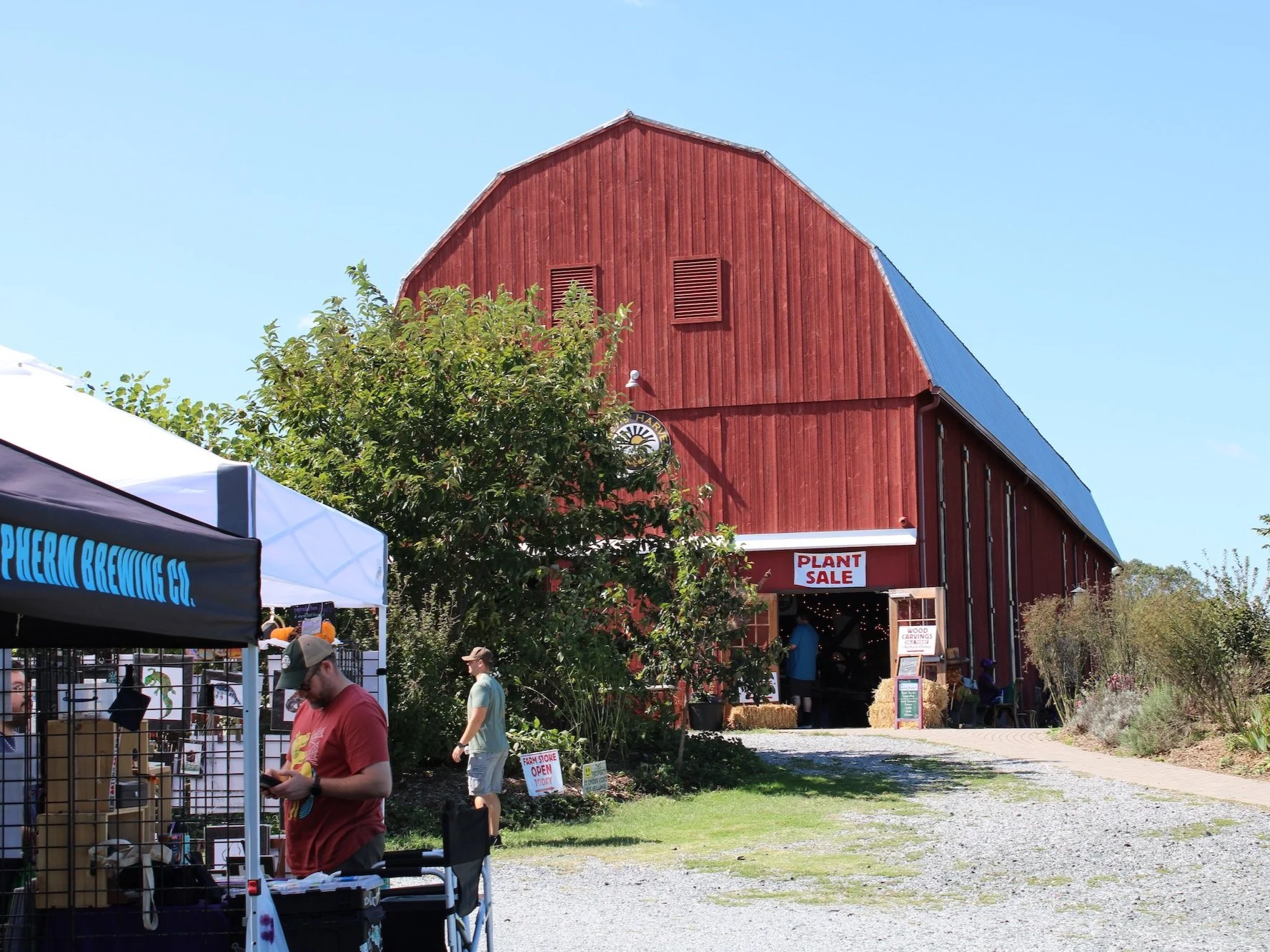 Large red barn with tents in foreground