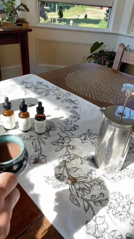 Mug full of chocolate with tinctures on table in background