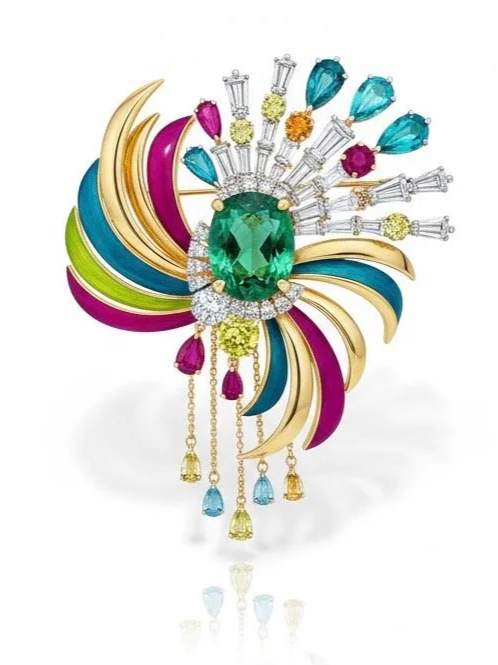 Colorful brooch featuring a large green gemstone, surrounded by smaller diamonds and multicolored stones, with gold and enamel accents resembling petals and feathers.