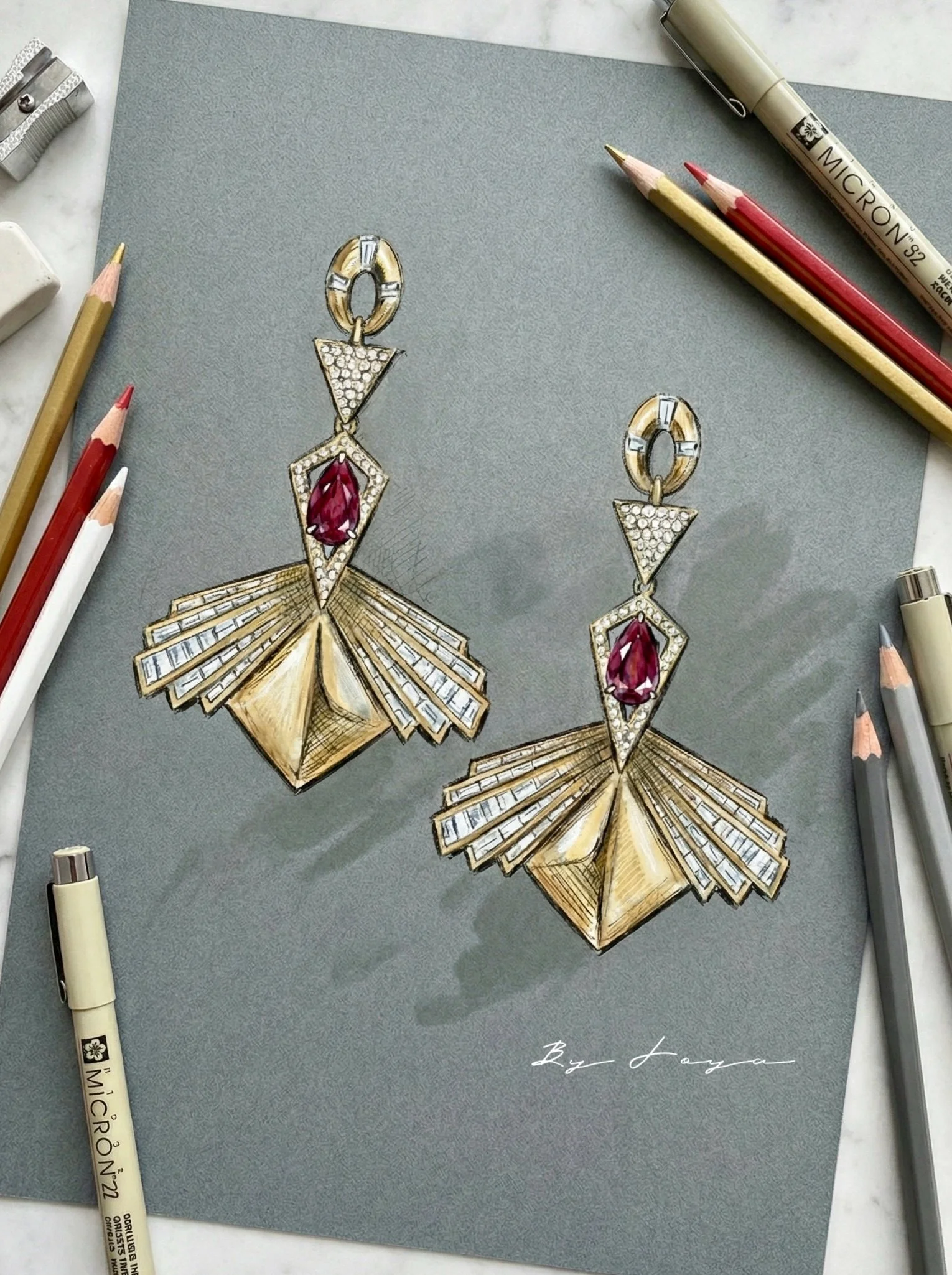 Drawing of a pair of gold and diamond earrings with red gemstones on a gray background, surrounded by colored pencils and markers.