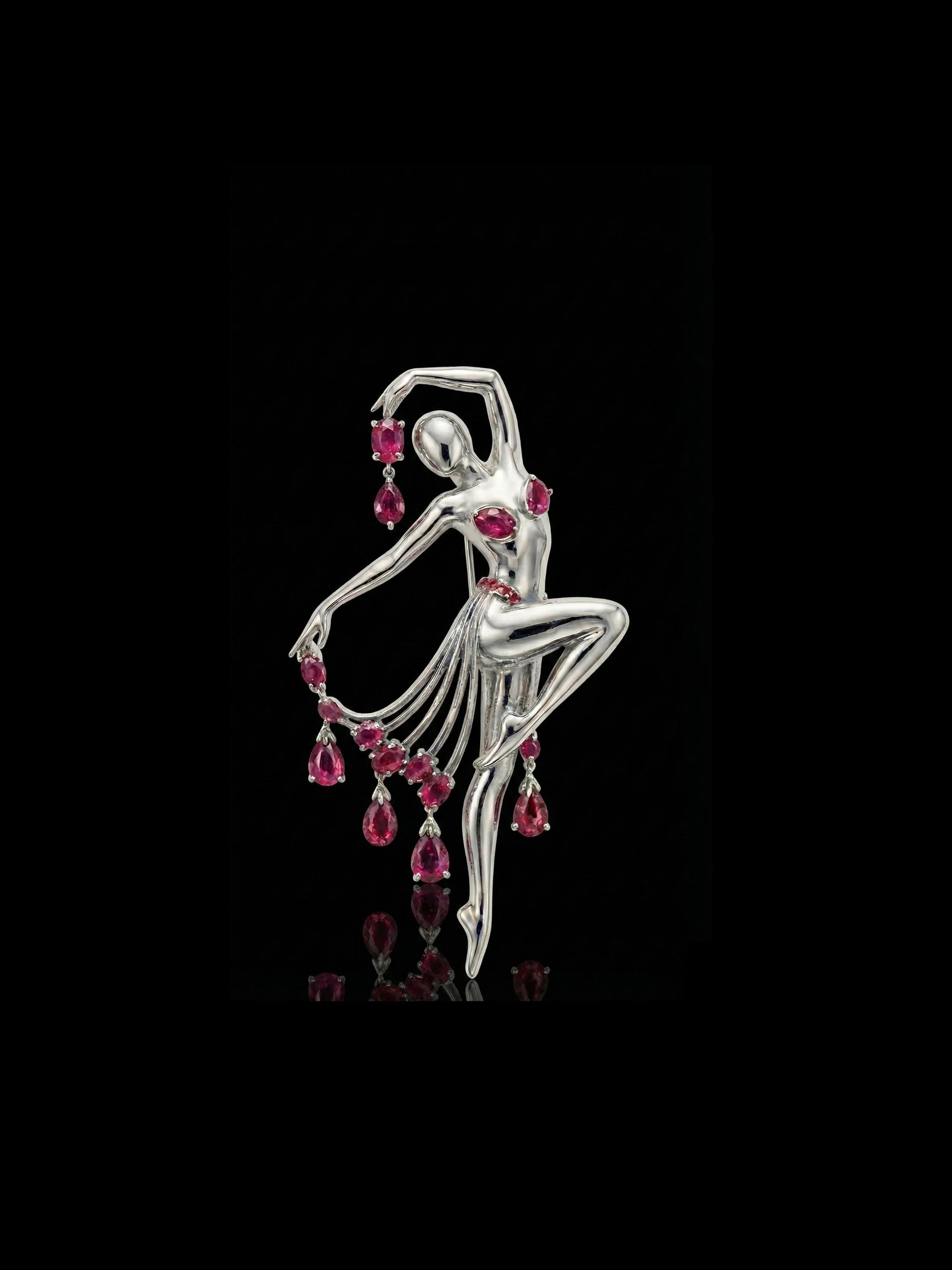 Silver ballerina brooch adorned with pink gemstones, featuring a dancer in a posed step with flowing skirt and hanging gemstone accents.