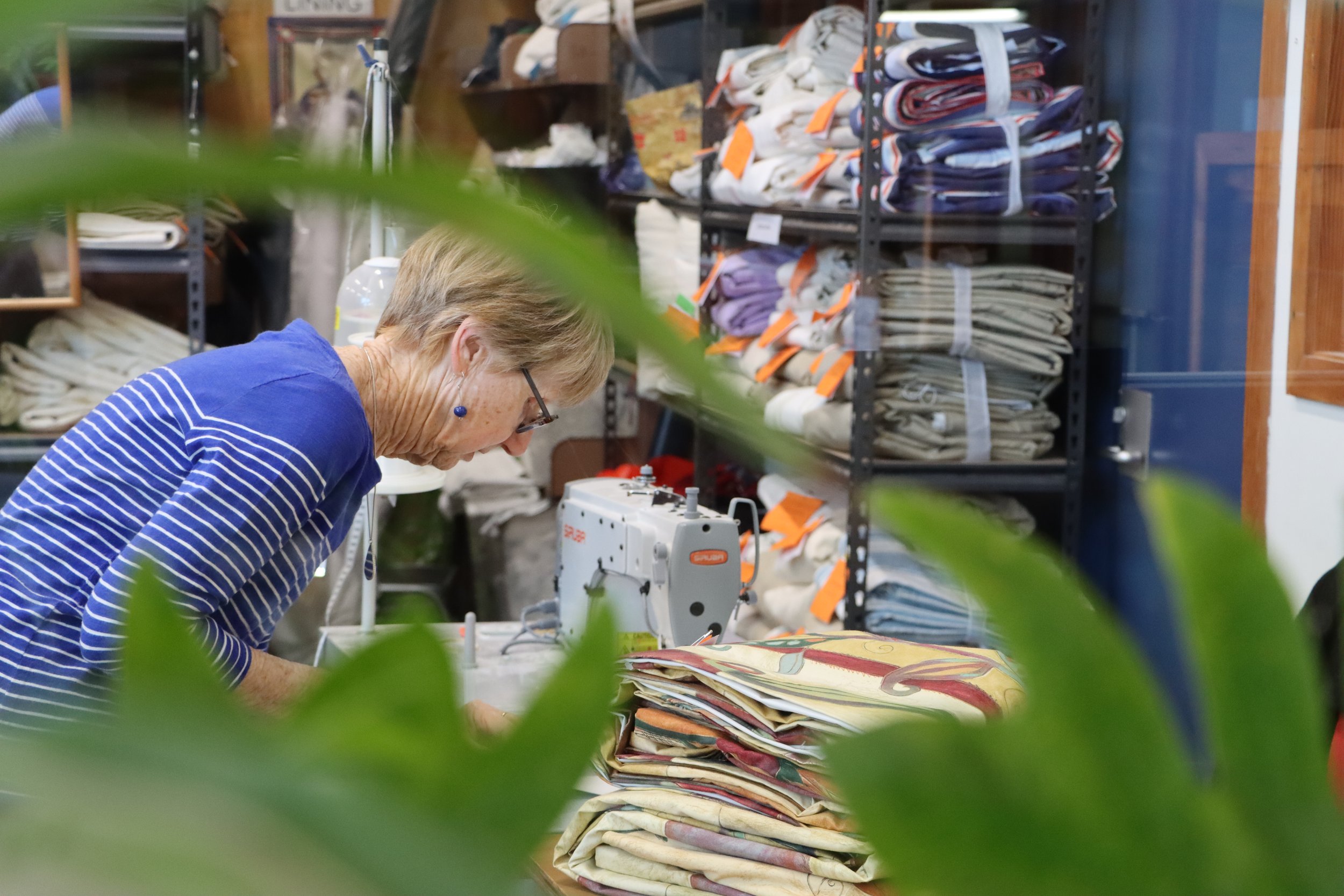 Volunteer sewing curtains.
