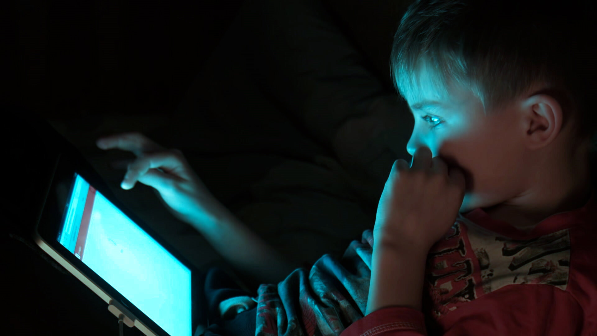 Boy on iPad blue light 2.jpg