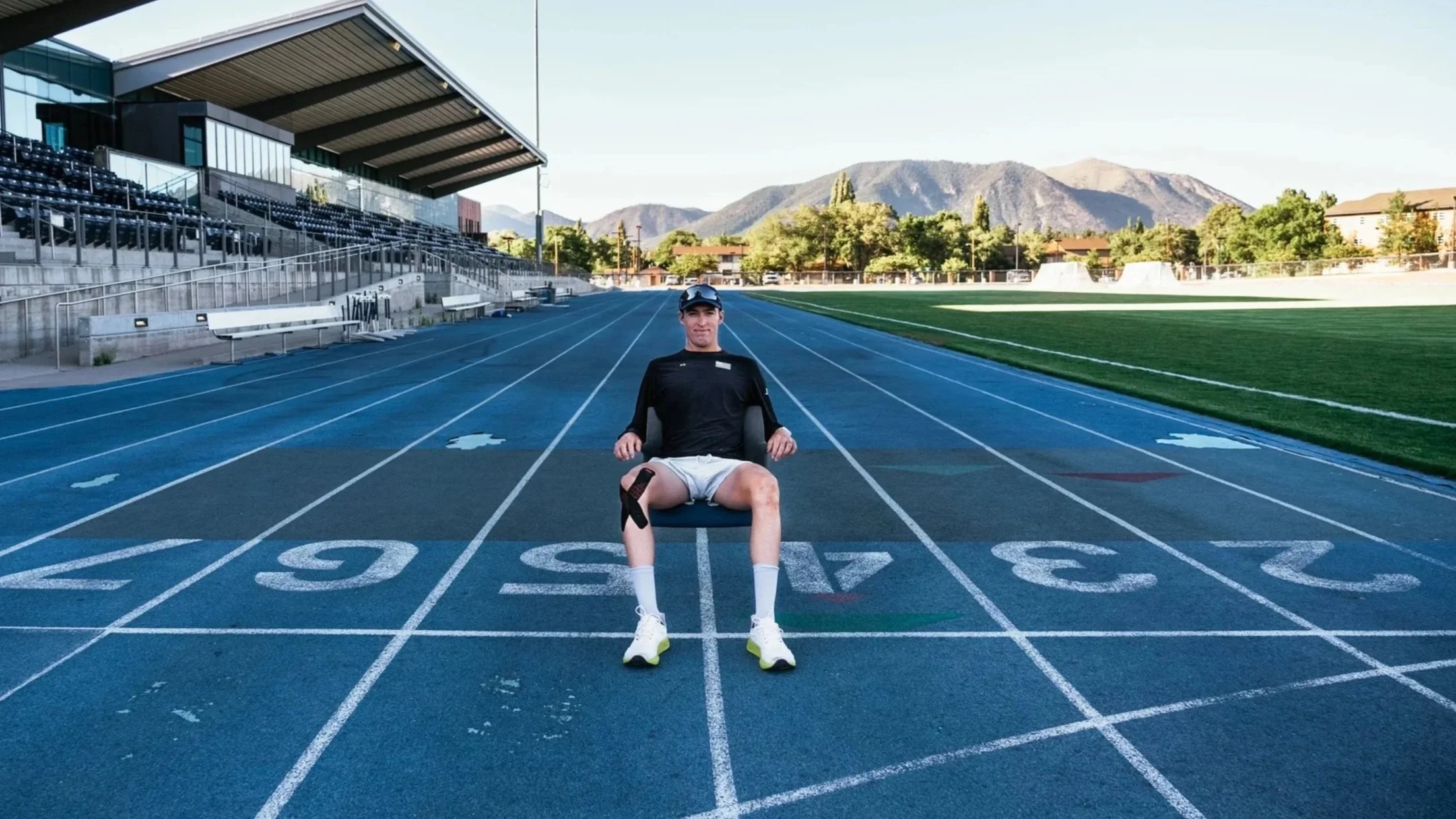 man sitting on a running track