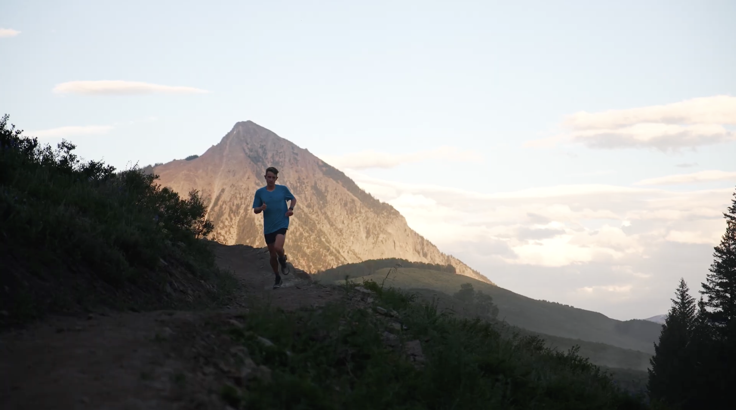 Taylor Stack running in front of Mt. Crested Butte