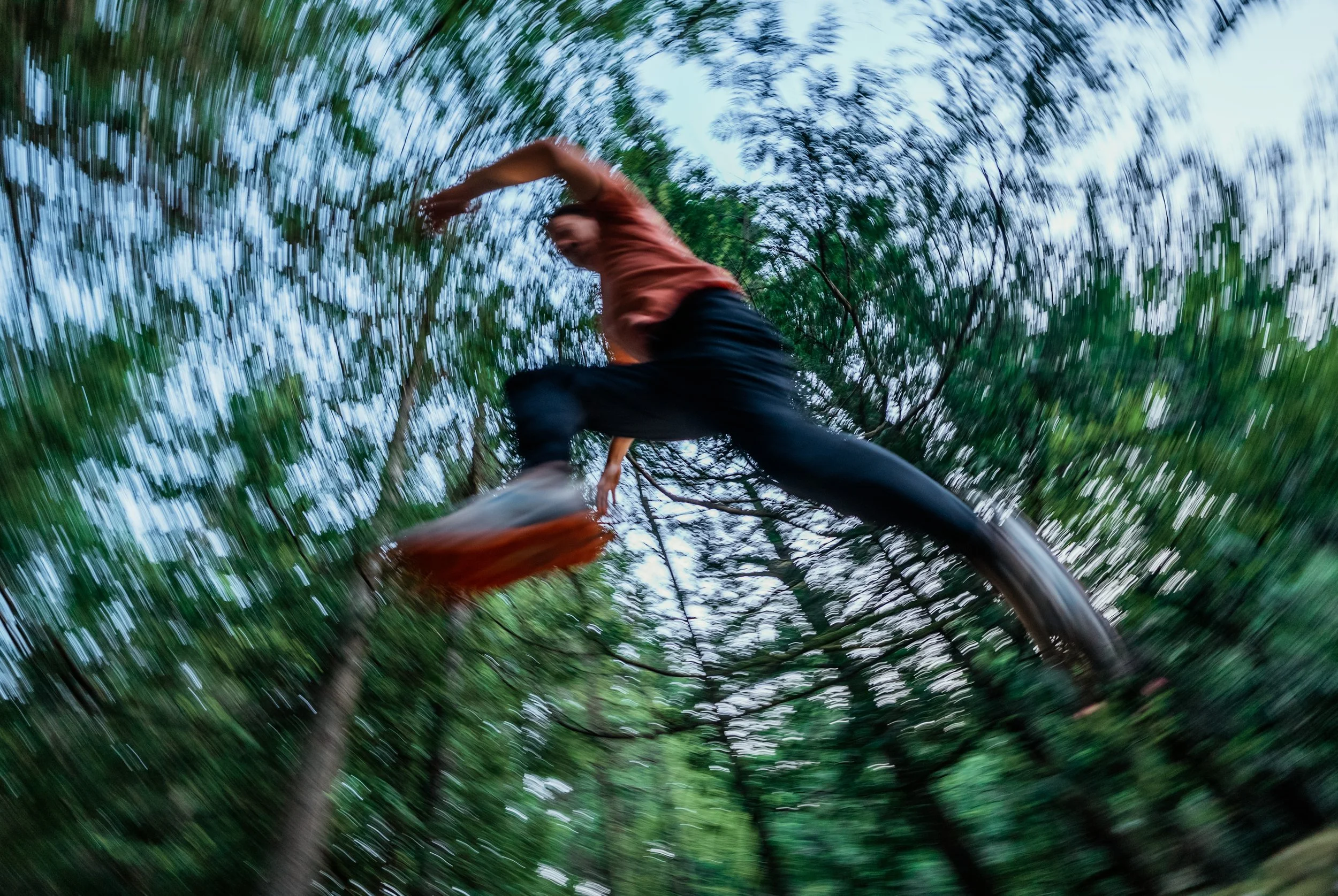 runner jumping through the trees, blurry vibes photo