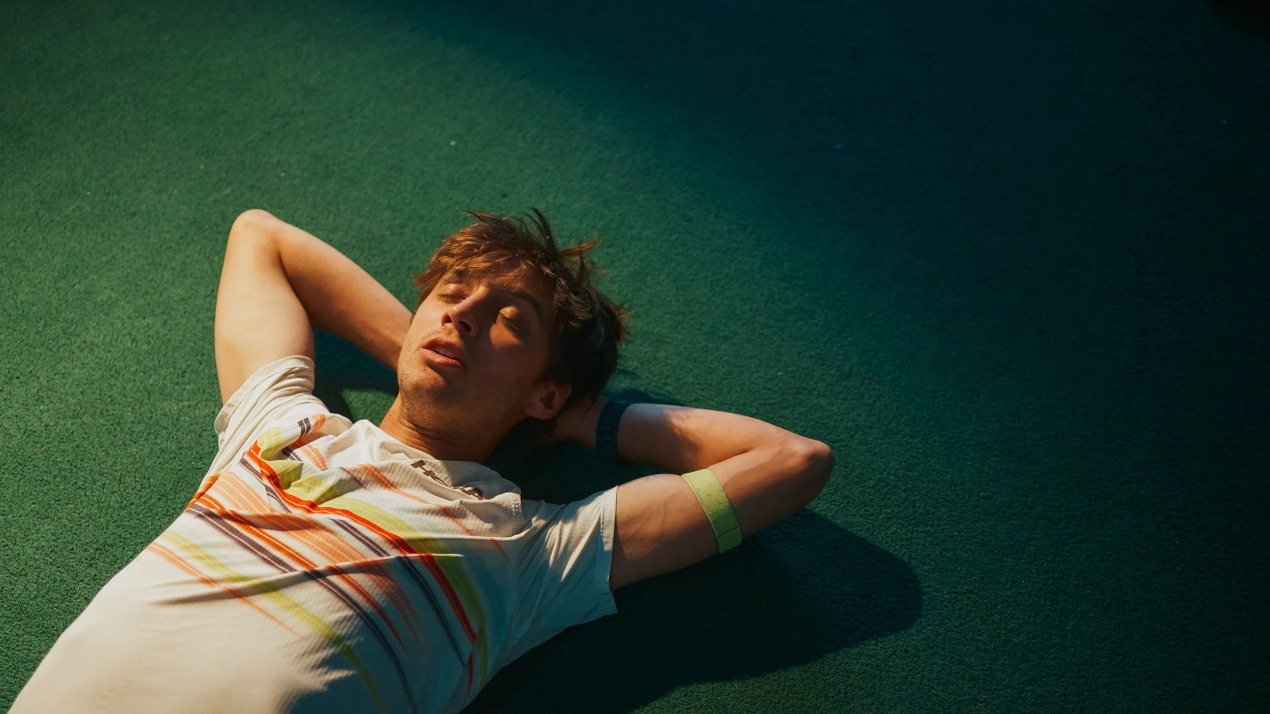 Hans Troyer laying on the ground in a gym in Boulder, Colorado