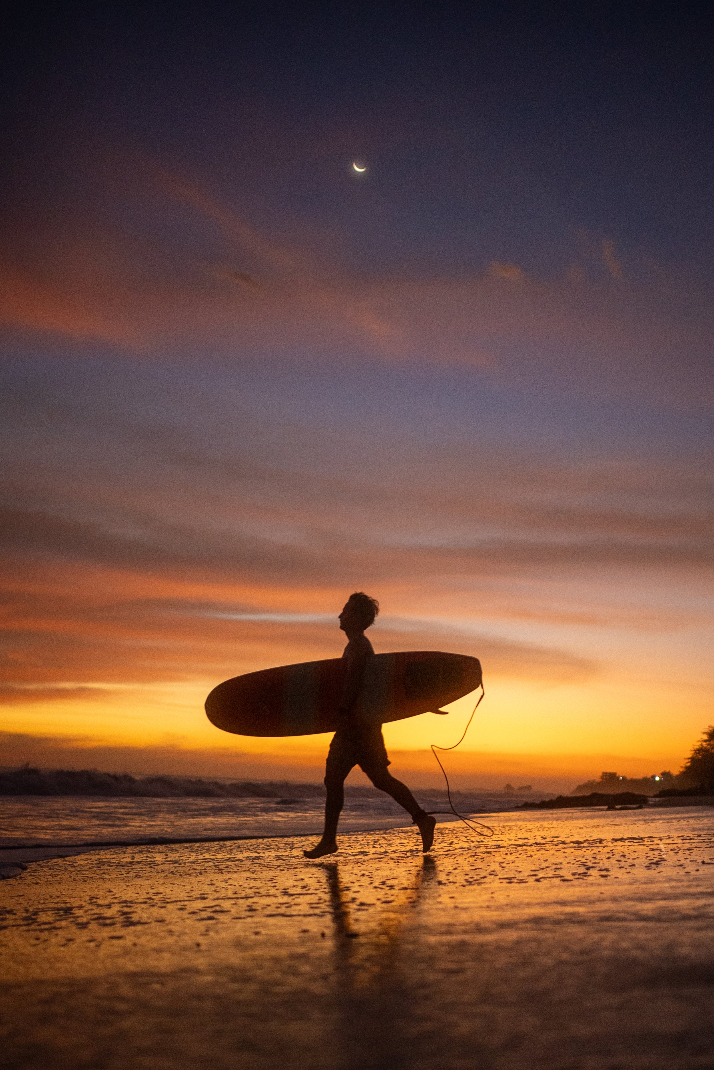 sunset photo of a surfer in central america