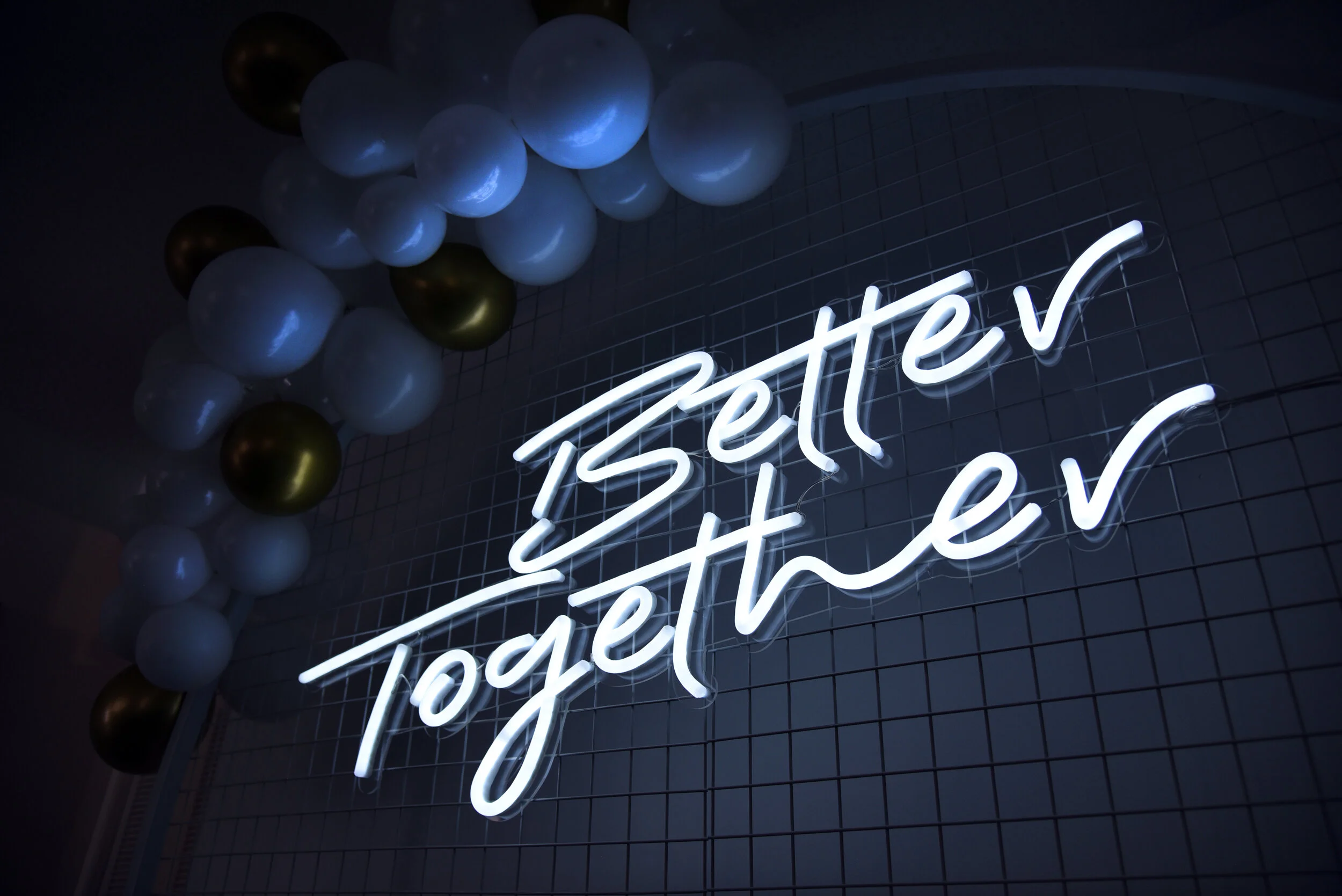 Better Together Neon Sign on White Mesh Backdrop 