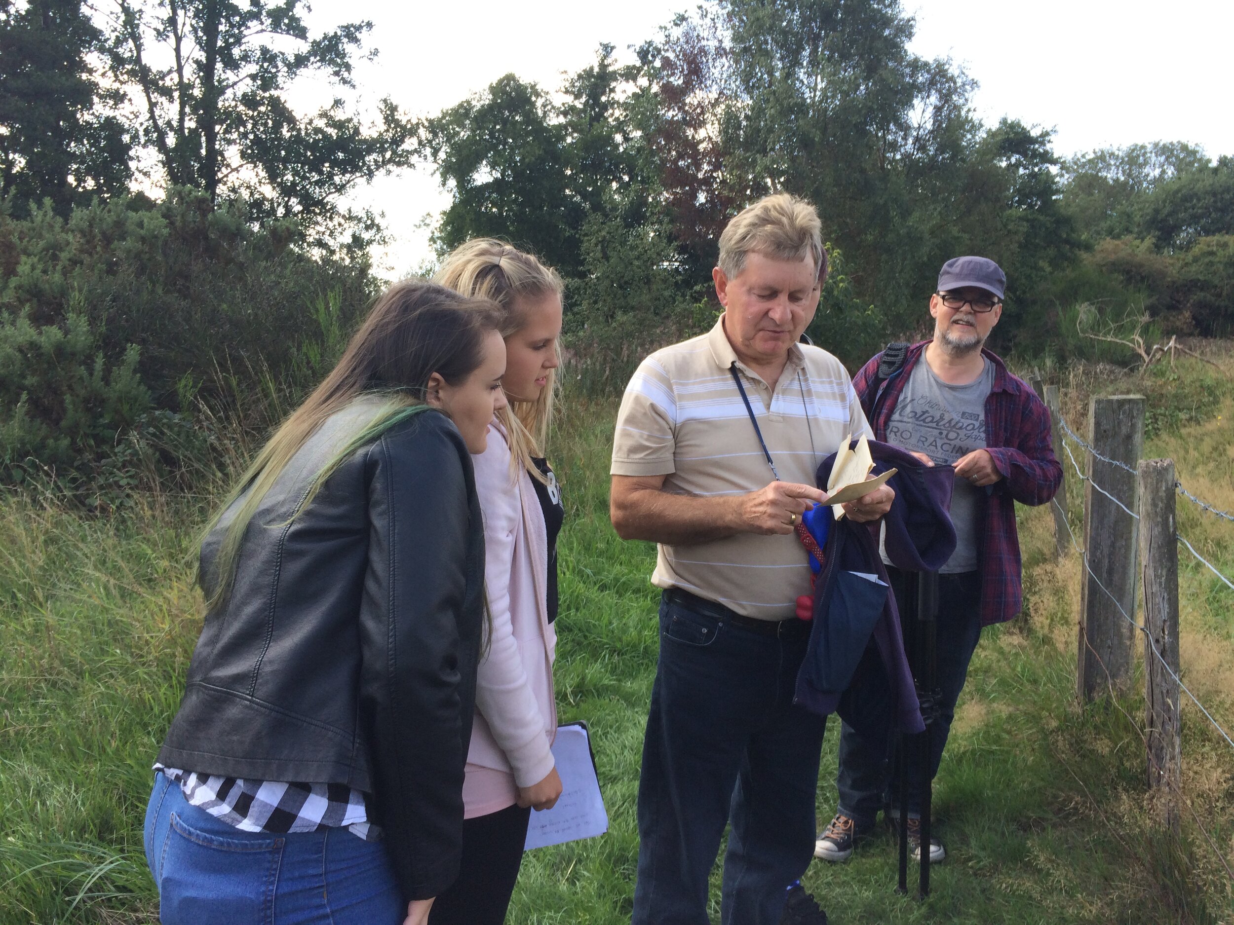 Group filming in a field