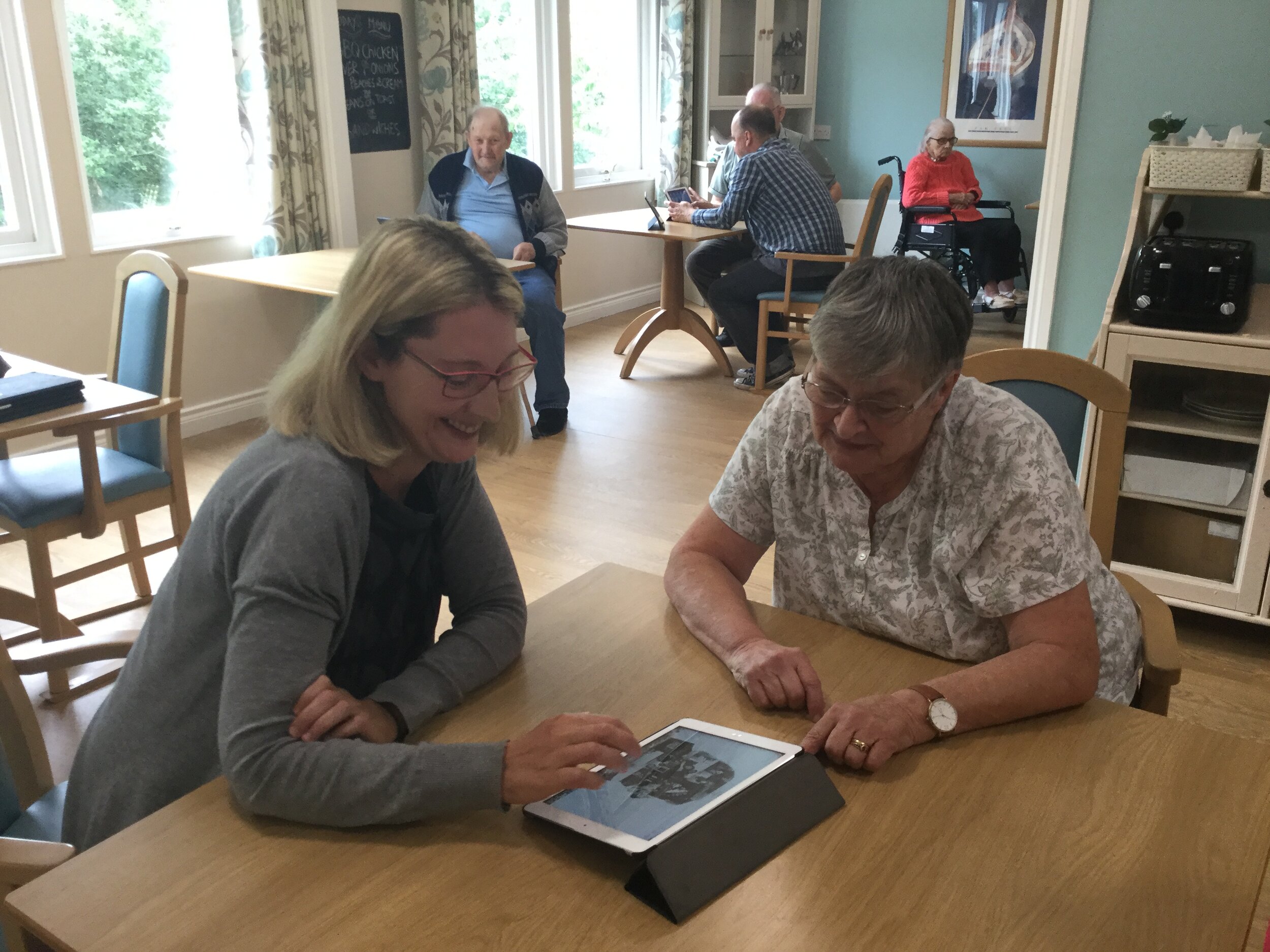 Two people working on the lifebook together 