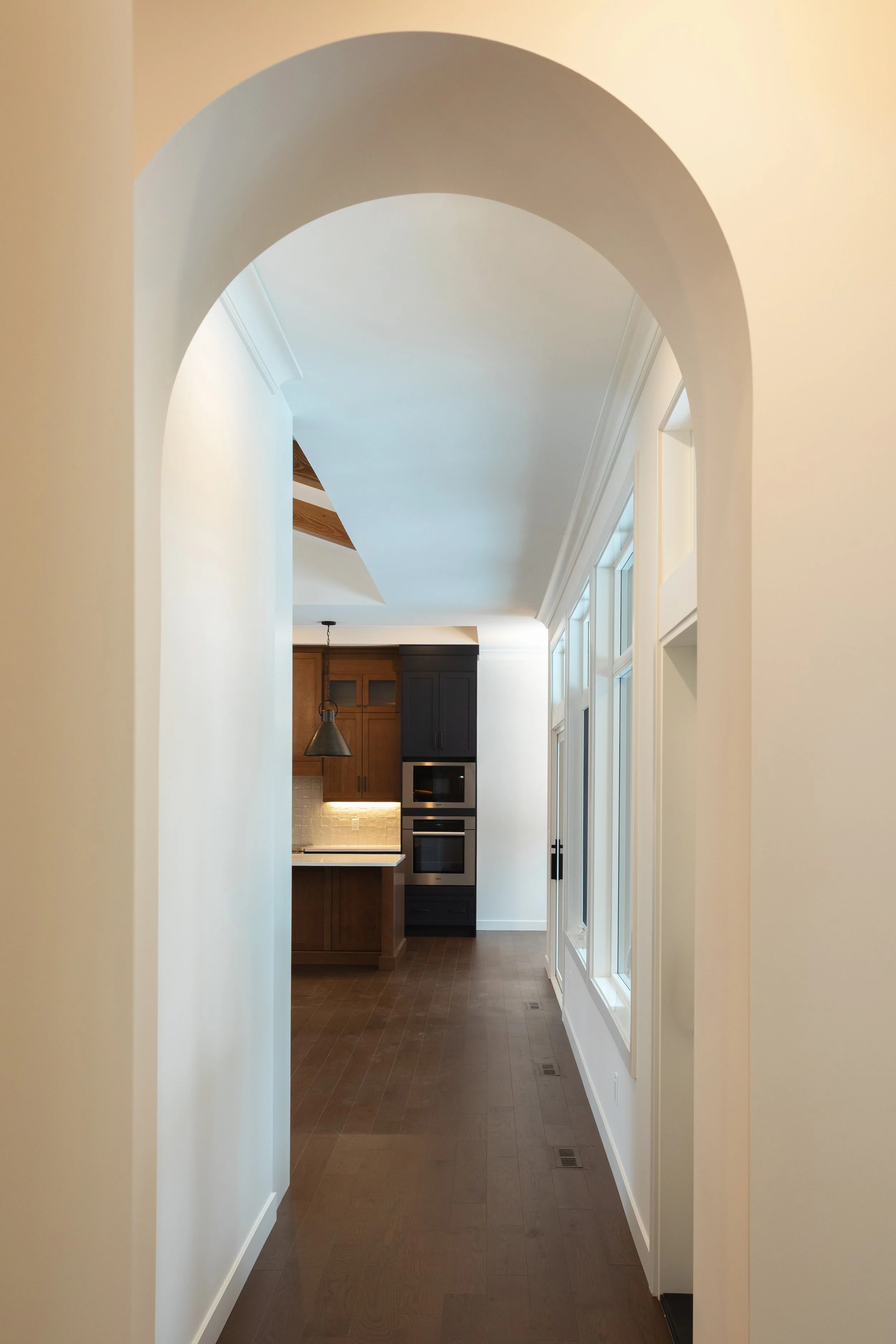 Arched entry in Parkview 89 custom home by Urbis Infill Homes in Edmonton.