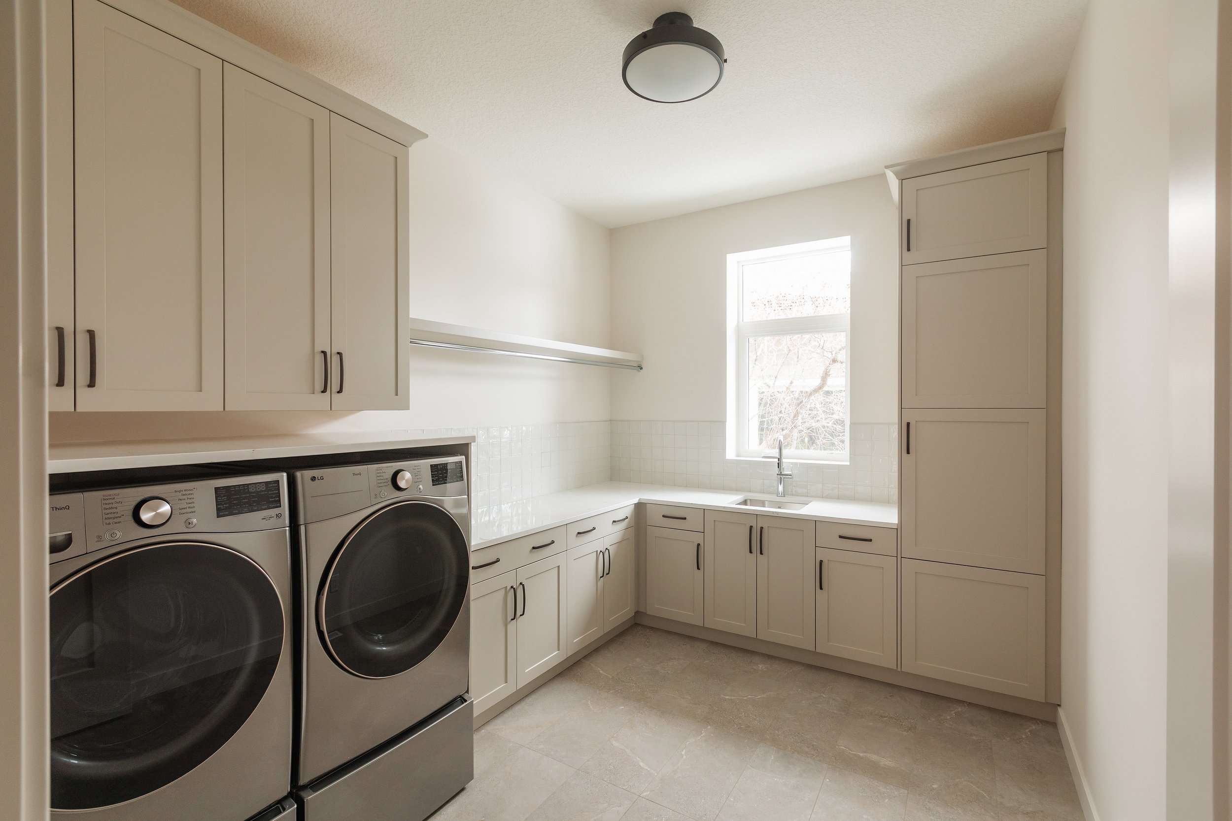 Laundry room in Parkview 89 custom home by Urbis Infill Homes in Edmonton.