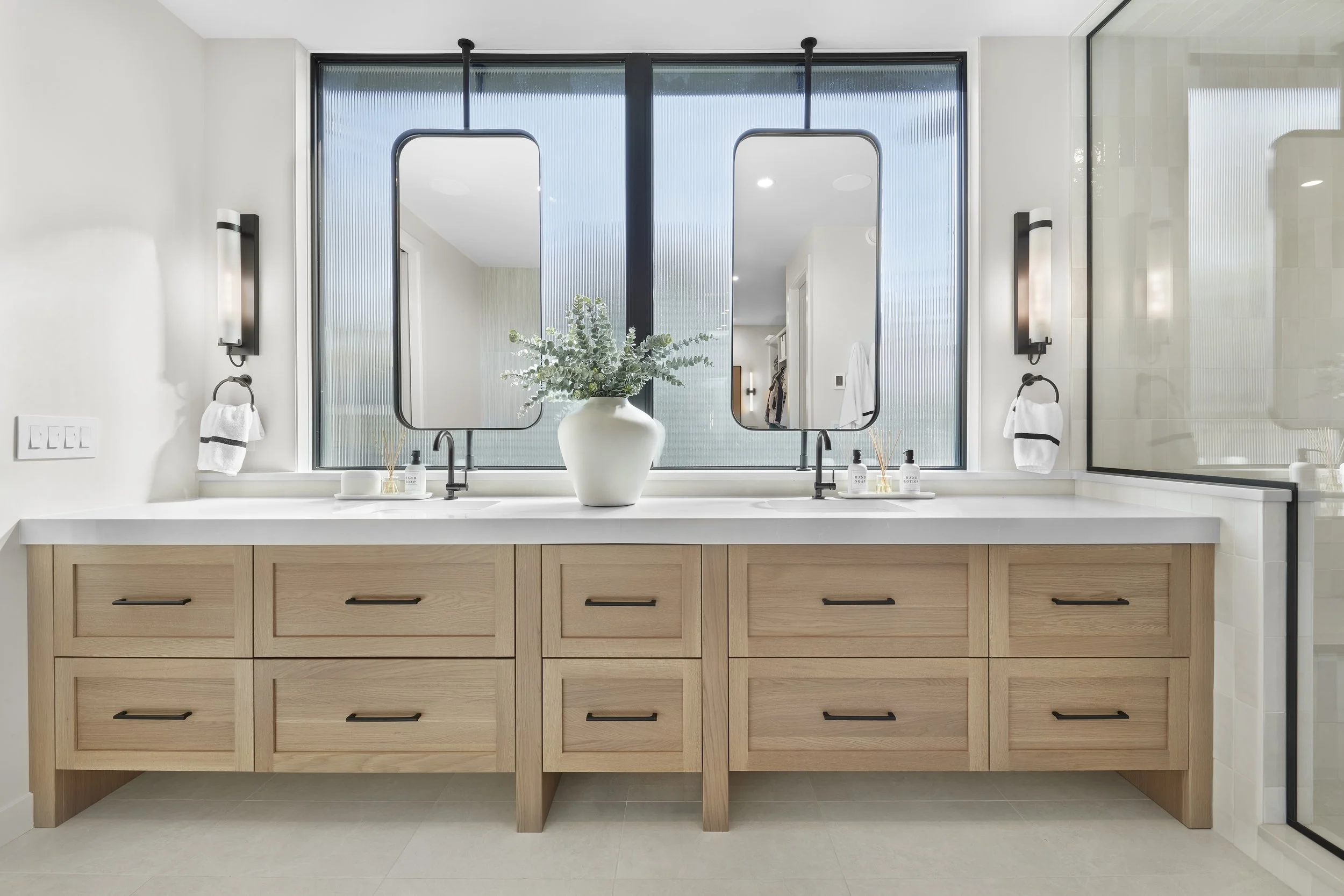 Vanity mirrors of Glenora 139 Custom by Urbis Infill Homes in Edmonton.