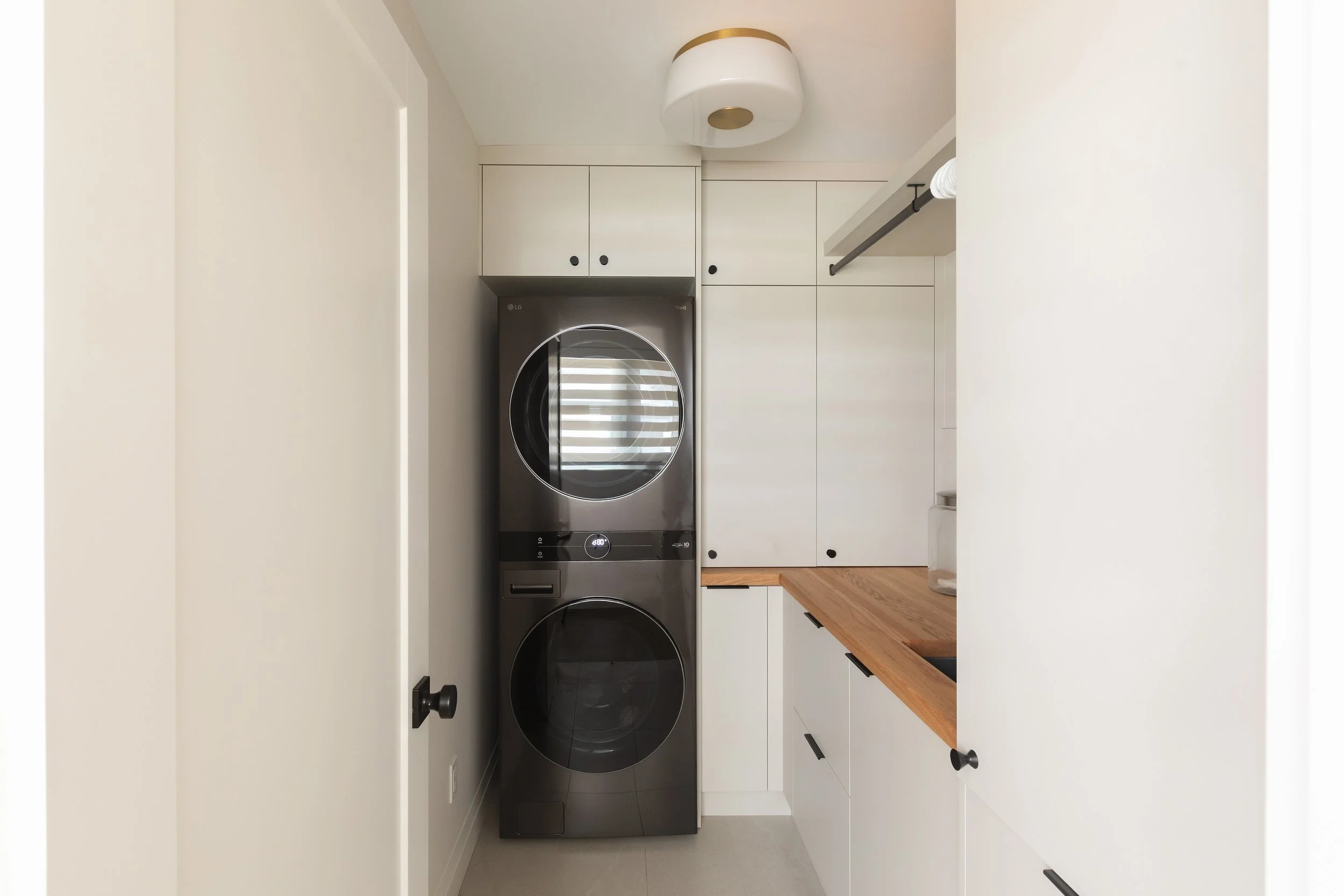 Laundry room in the Sherwood Park Reno by Urbis Infill Homes.