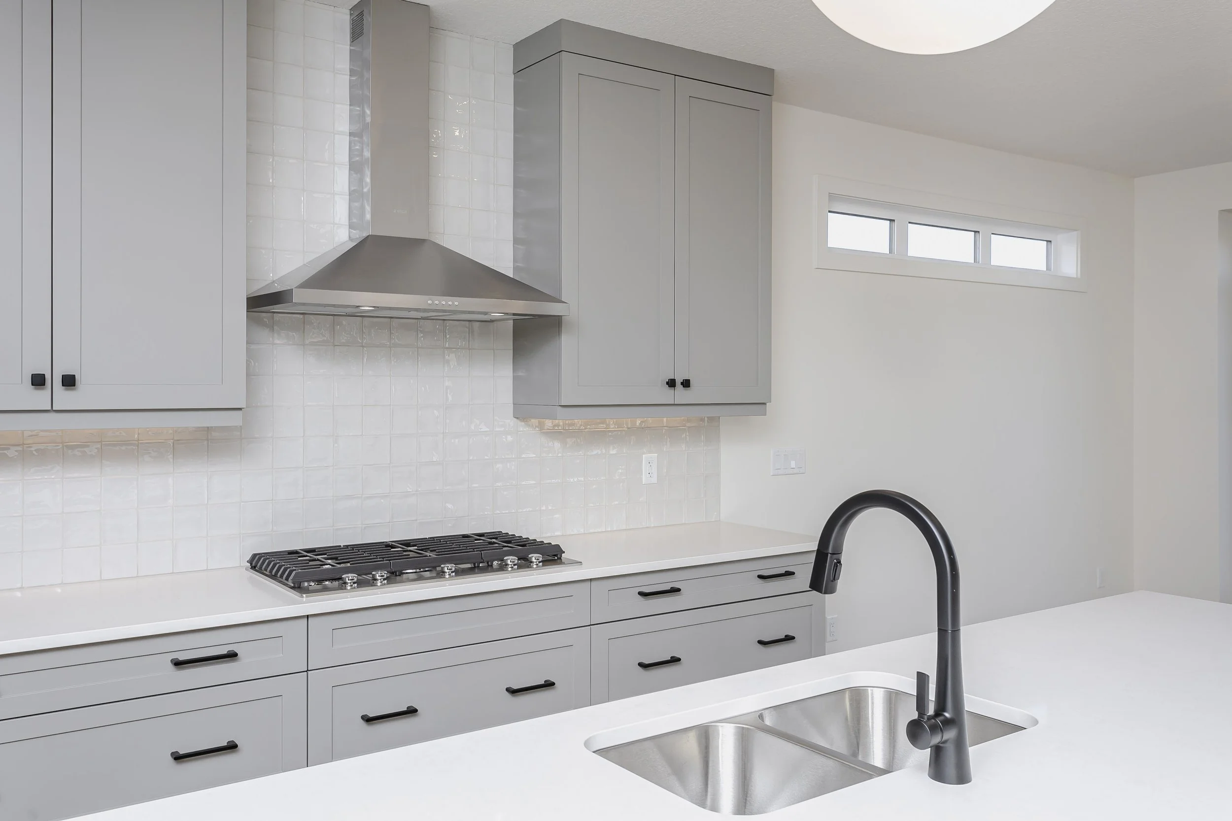 Kitchen faucet in the Farmhouse at 51 Jubilation Drive by Urbis Infill Homes in Jensen Lakes.