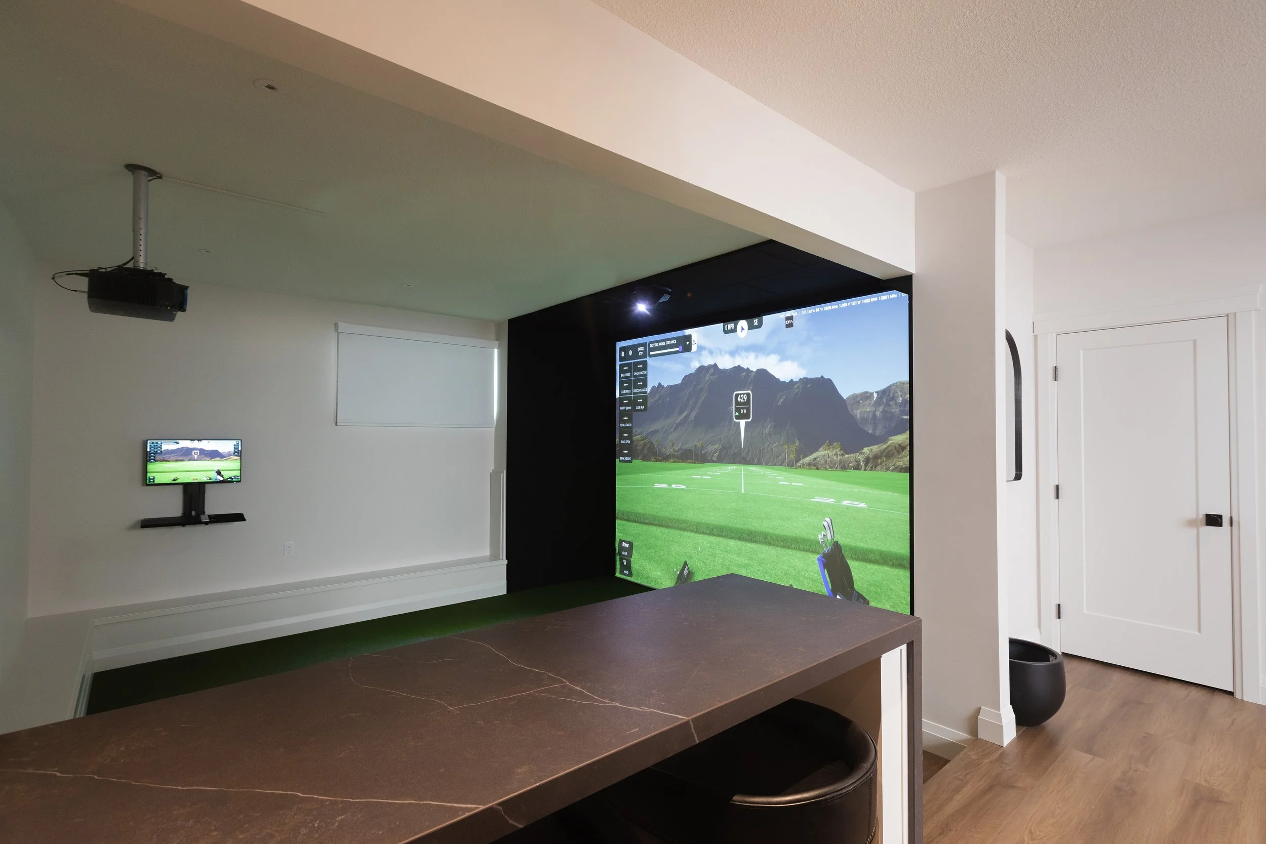 Golf sim in the Sherwood Park Reno by Urbis Infill Homes.