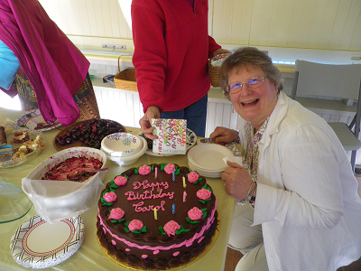 Carol B is excited about her birthday cake.
