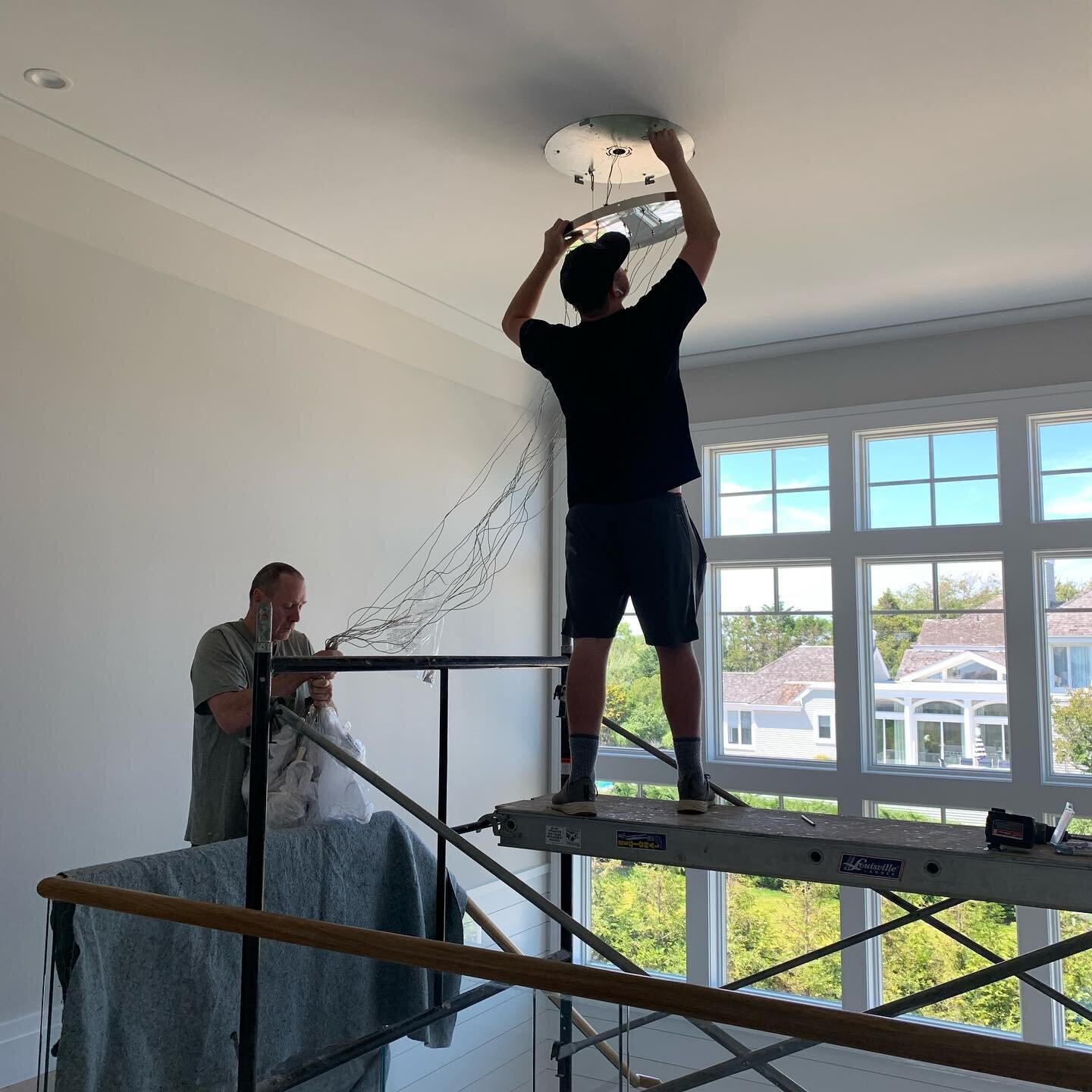 Second story light fixture installation can be nerve-racking but this one was worth it! #lightingisart #styledandsold #luxuryhomedesign #hamptonsdesigner #c2rconstruction #waterfronthomes