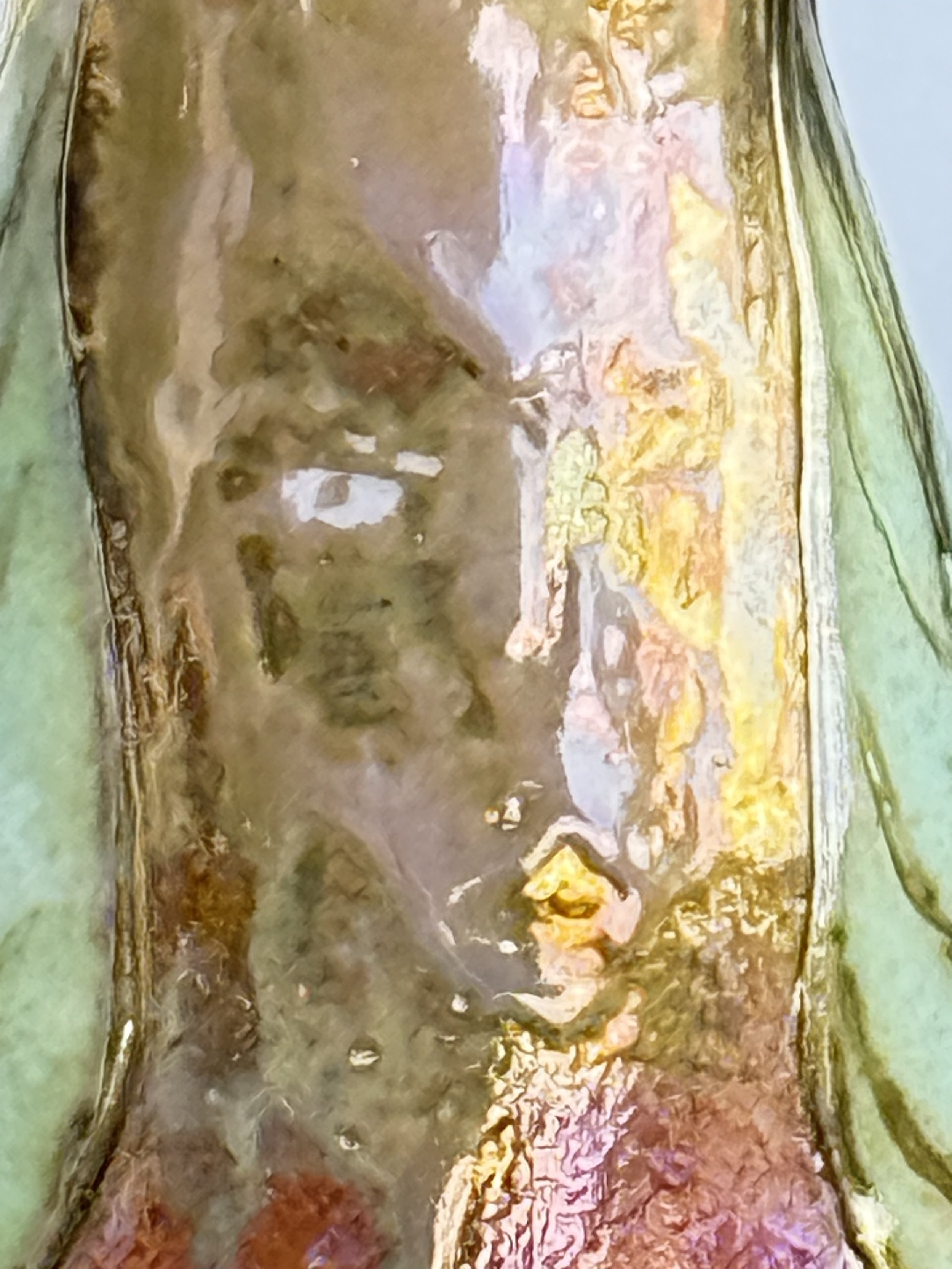 A Genie looking out from the Neck of a tall in-glazed lustre paper clay vessel. come and see where she is gazing from.