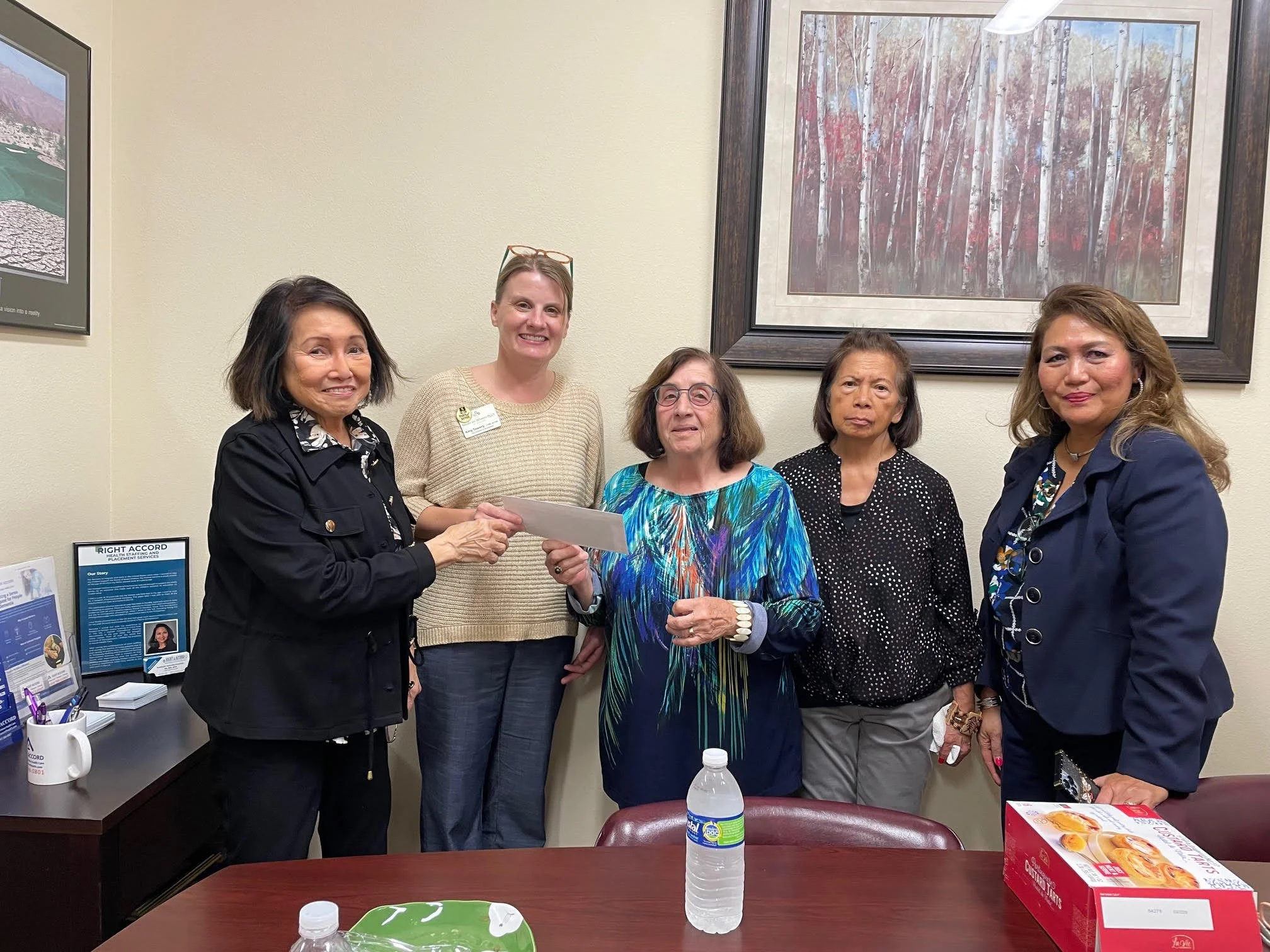 AAWA February meeting 2025 Presentation of AAWA donation check to Manatee Food Bank. Amy Towery, VP Development