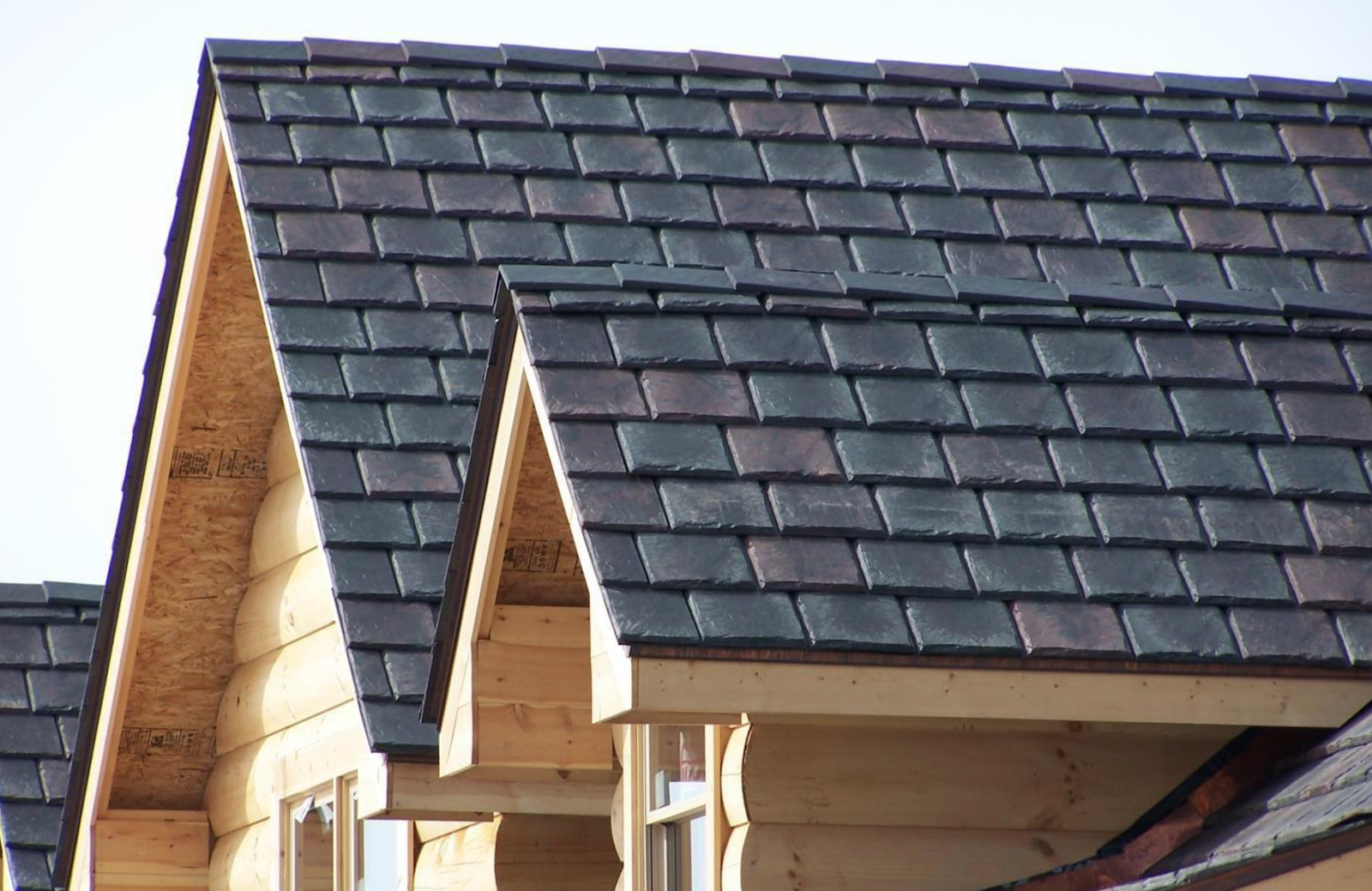 Composite synthetic slate roof with textured panels resembling natural slate.