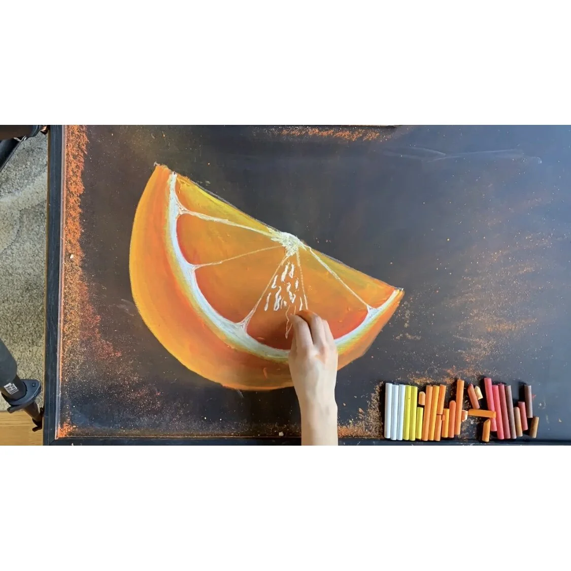 11. Drawing the pulp highlights: Using white chalk, start at the top of each segment and draw linear squiggles towards the bottom. Free-style this part. I made too many thin lines on this orange. Instead draw fatter squiggles to contrast the skinn