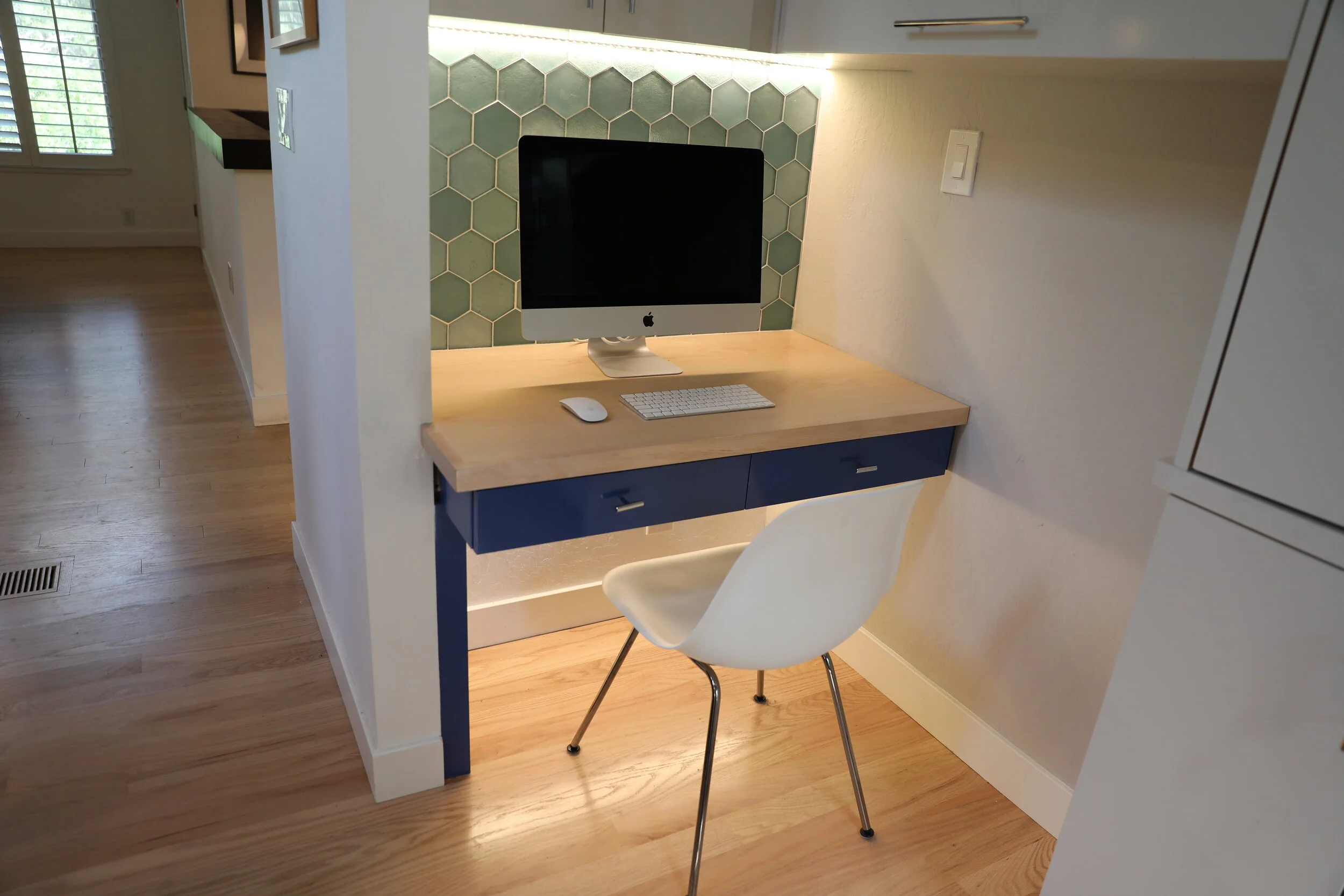 A personal desk area for the computer, mail and personal items needed to be tucked away to hide clutter but still conveniently located near the kitchen. 